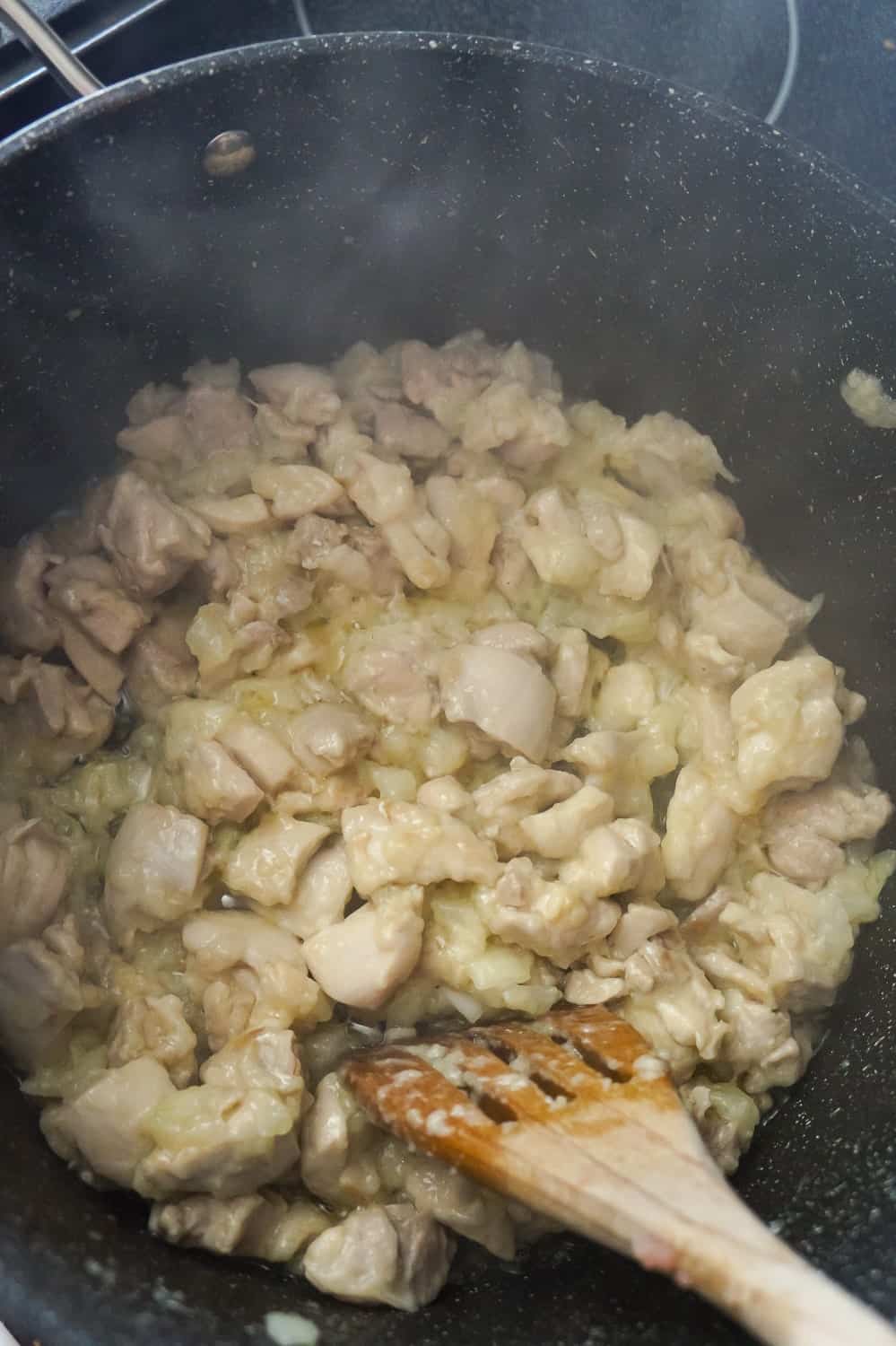 chicken pieces, diced onions, butter and flour cooking in a pot