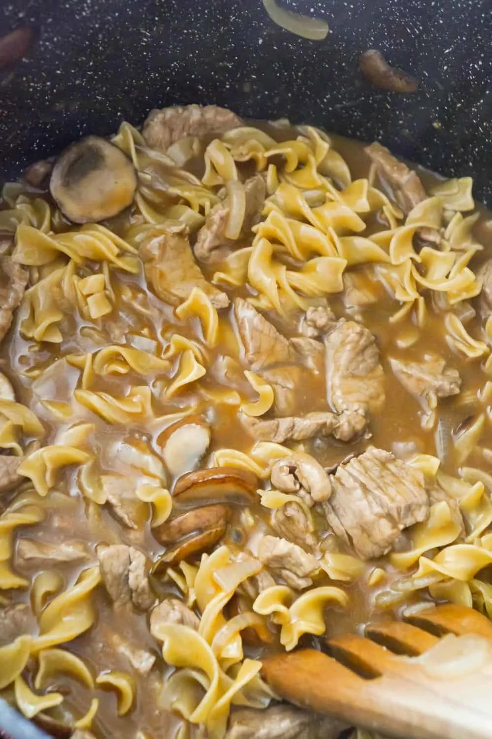 steak and noodles with gravy in a large pan