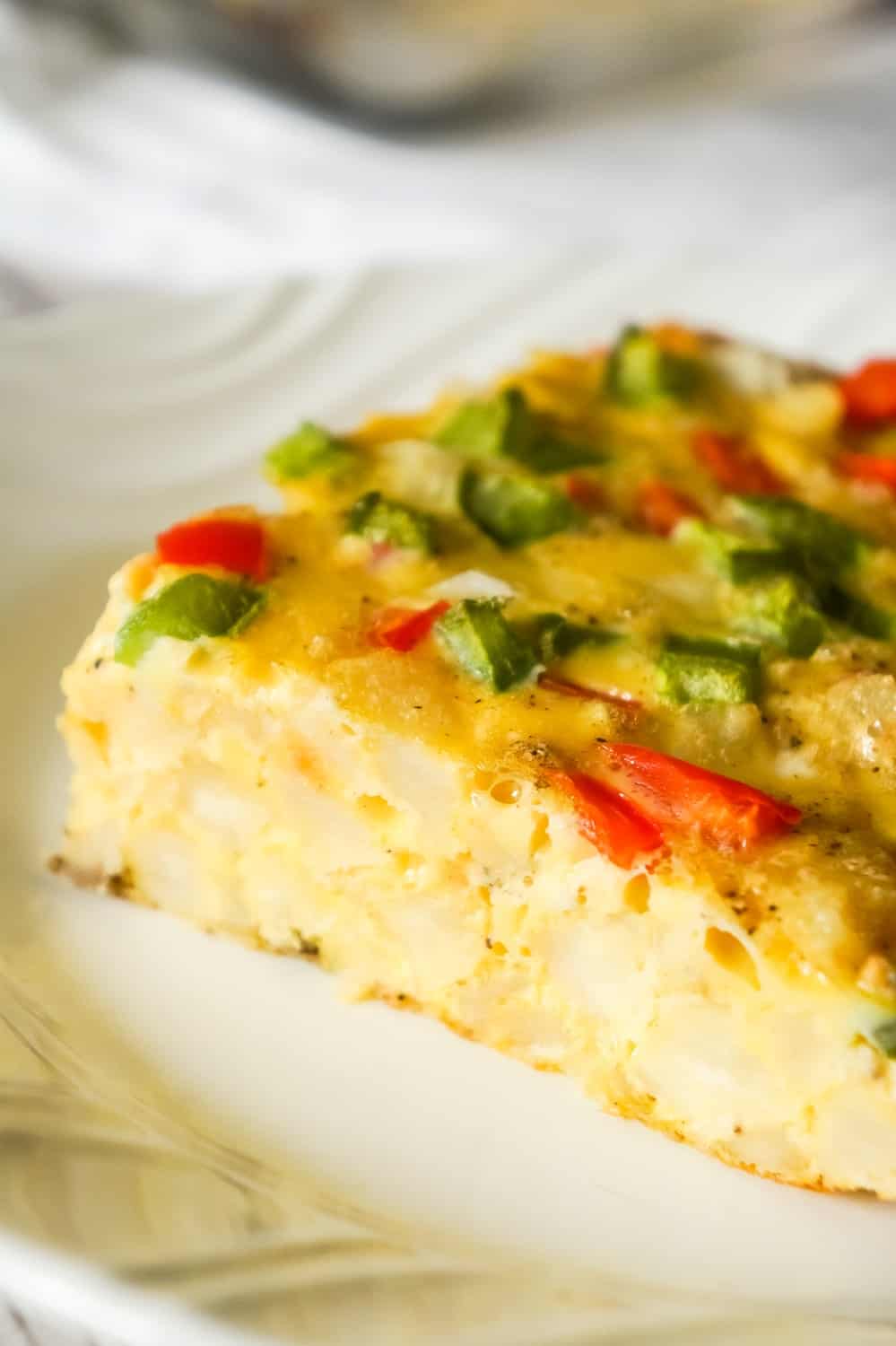 Egg Casserole with Hash Browns is a an easy breakfast recipe made with diced hash brown potatoes and loaded with onions, green peppers and red peppers.