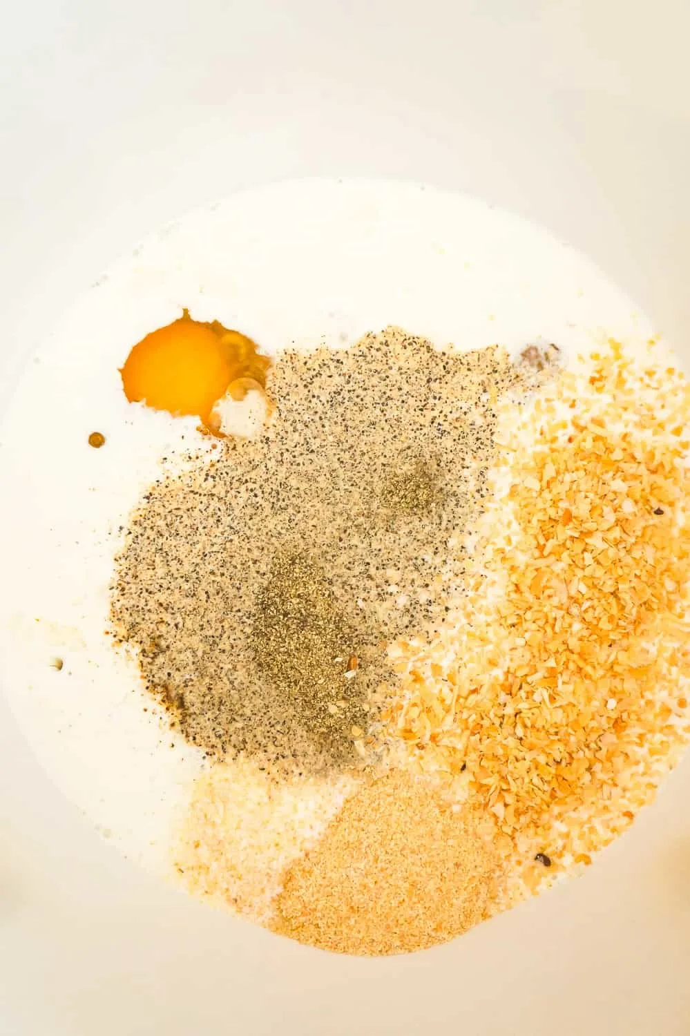 eggs, cream and spices in a mixing bowl