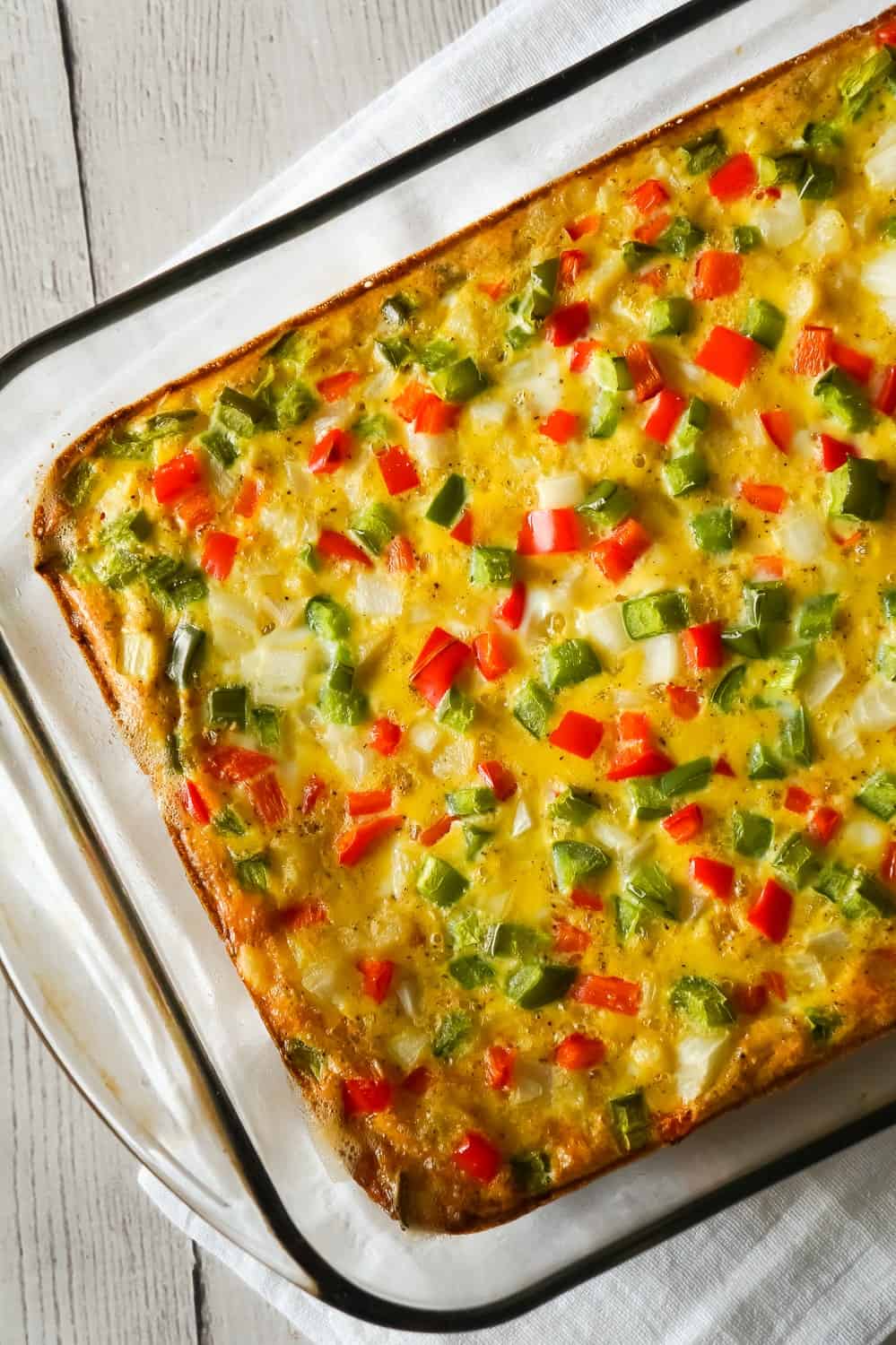 Egg Casserole with Hash Browns is a an easy breakfast recipe made with diced hash brown potatoes and loaded with onions, green peppers and red peppers.