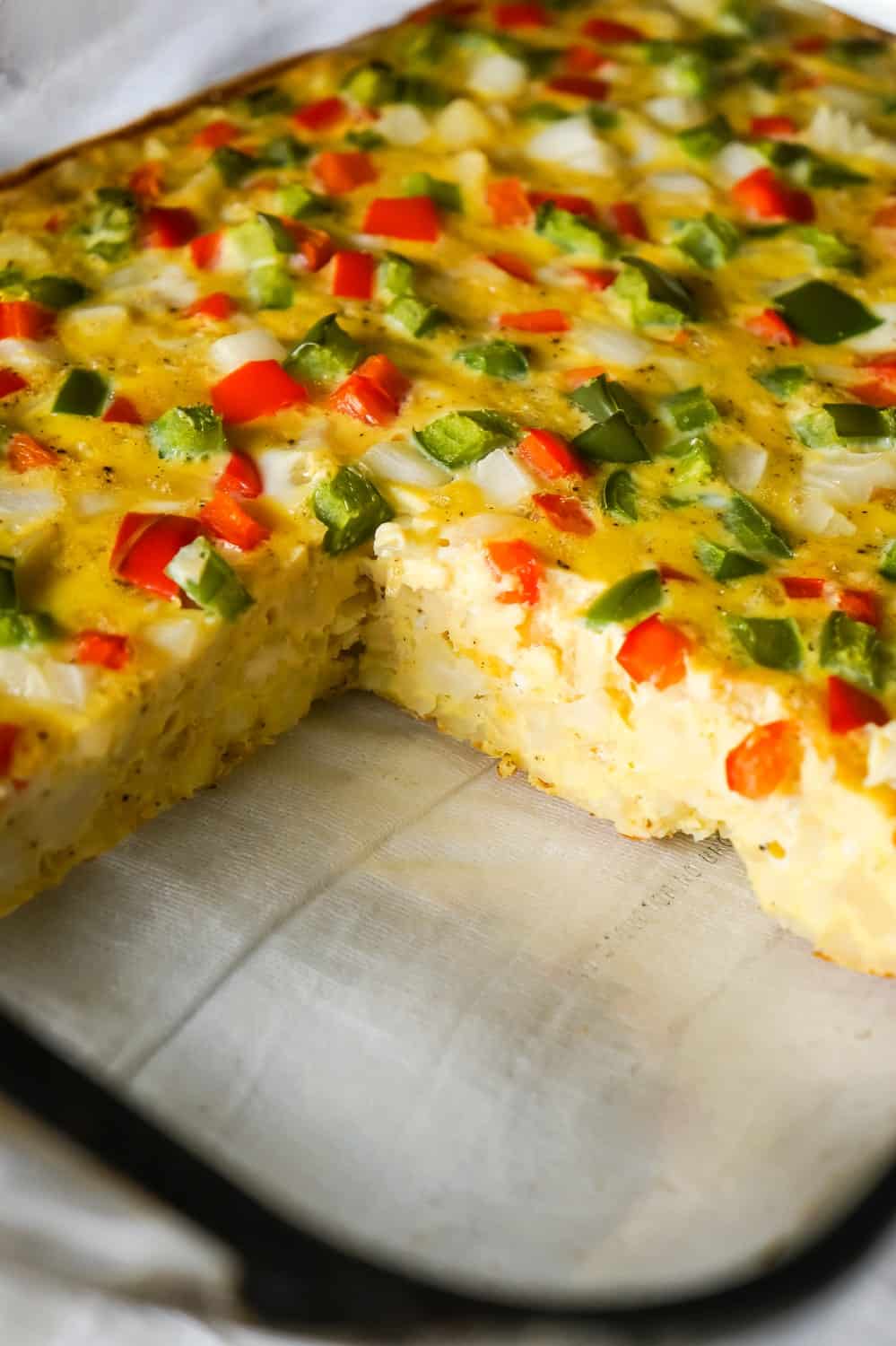 Egg Casserole with Hash Browns is a an easy breakfast recipe made with diced hash brown potatoes and loaded with onions, green peppers and red peppers.