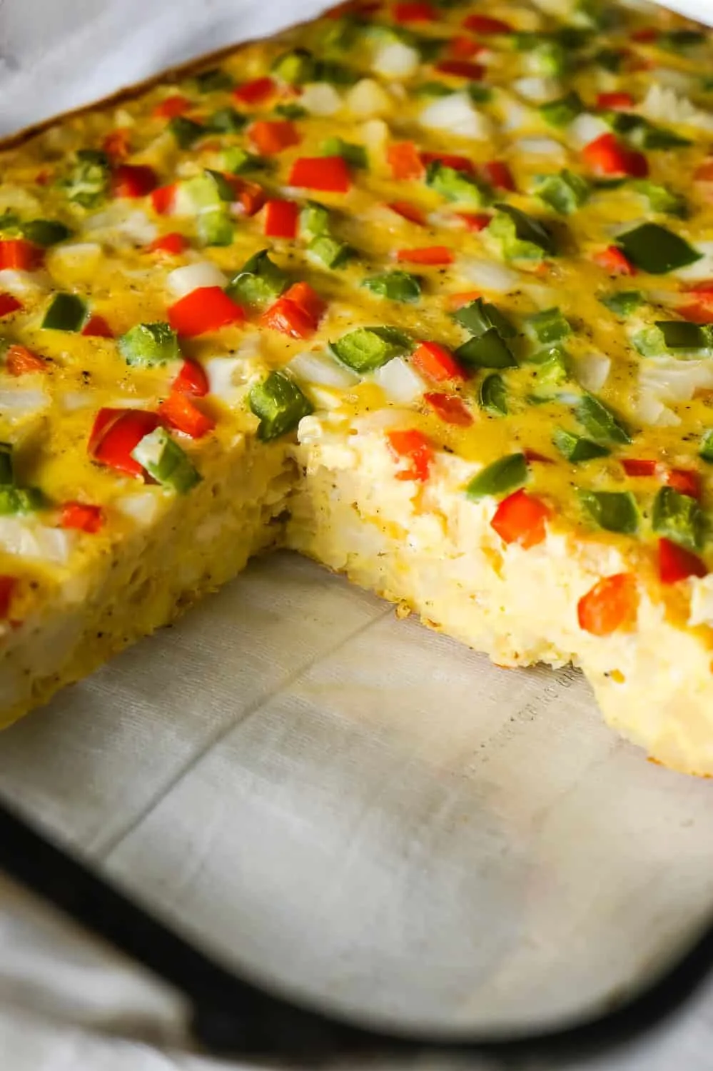 Egg Casserole with Hash Browns is a an easy breakfast recipe made with diced hash brown potatoes and loaded with onions, green peppers and red peppers.