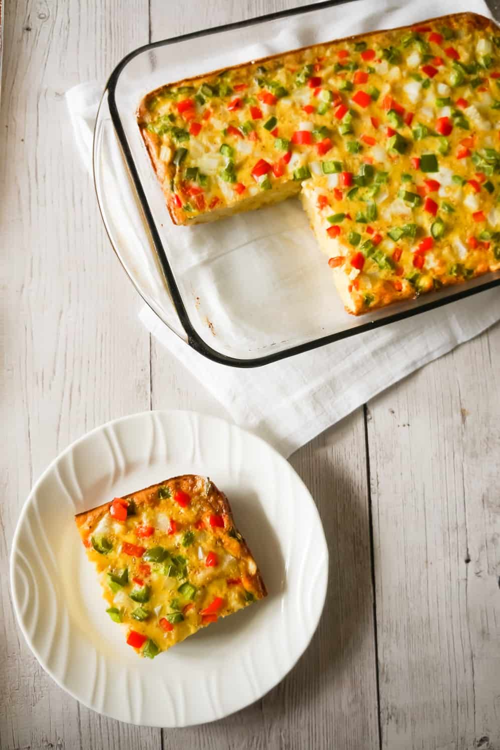 Egg Casserole with Hash Browns is a an easy breakfast recipe made with diced hash brown potatoes and loaded with onions, green peppers and red peppers.