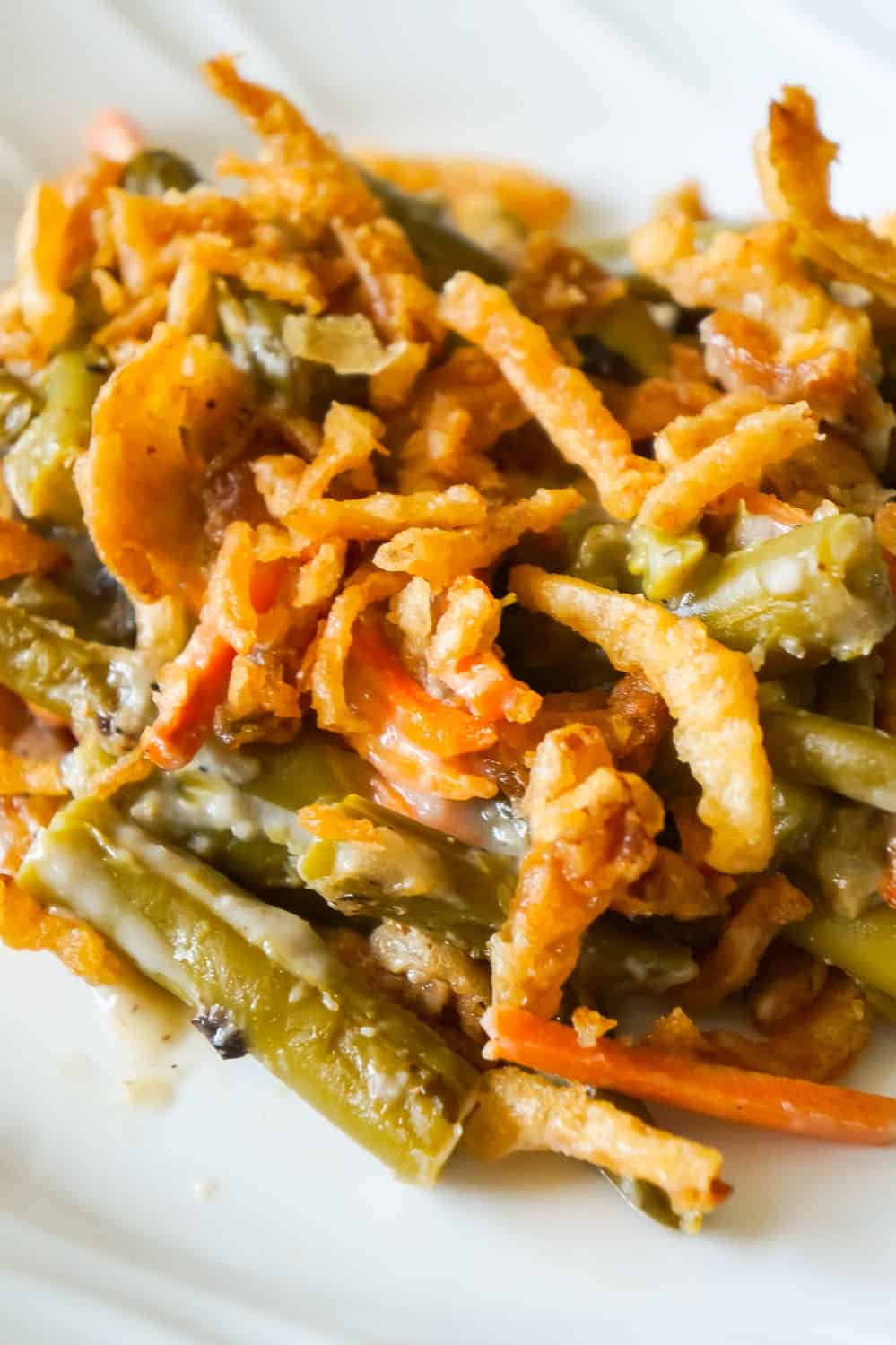 Green Bean Casserole with Campbell's Soup is a simple and delicious side dish recipe made with canned green beans, matchstick carrots, cream of mushroom soup and French's fried onions.