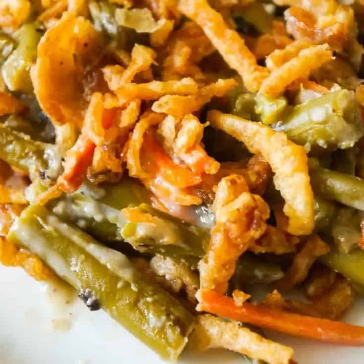 Green Bean Casserole with Campbell's Soup is a simple and delicious side dish recipe made with canned green beans, matchstick carrots, cream of mushroom soup and French's fried onions.