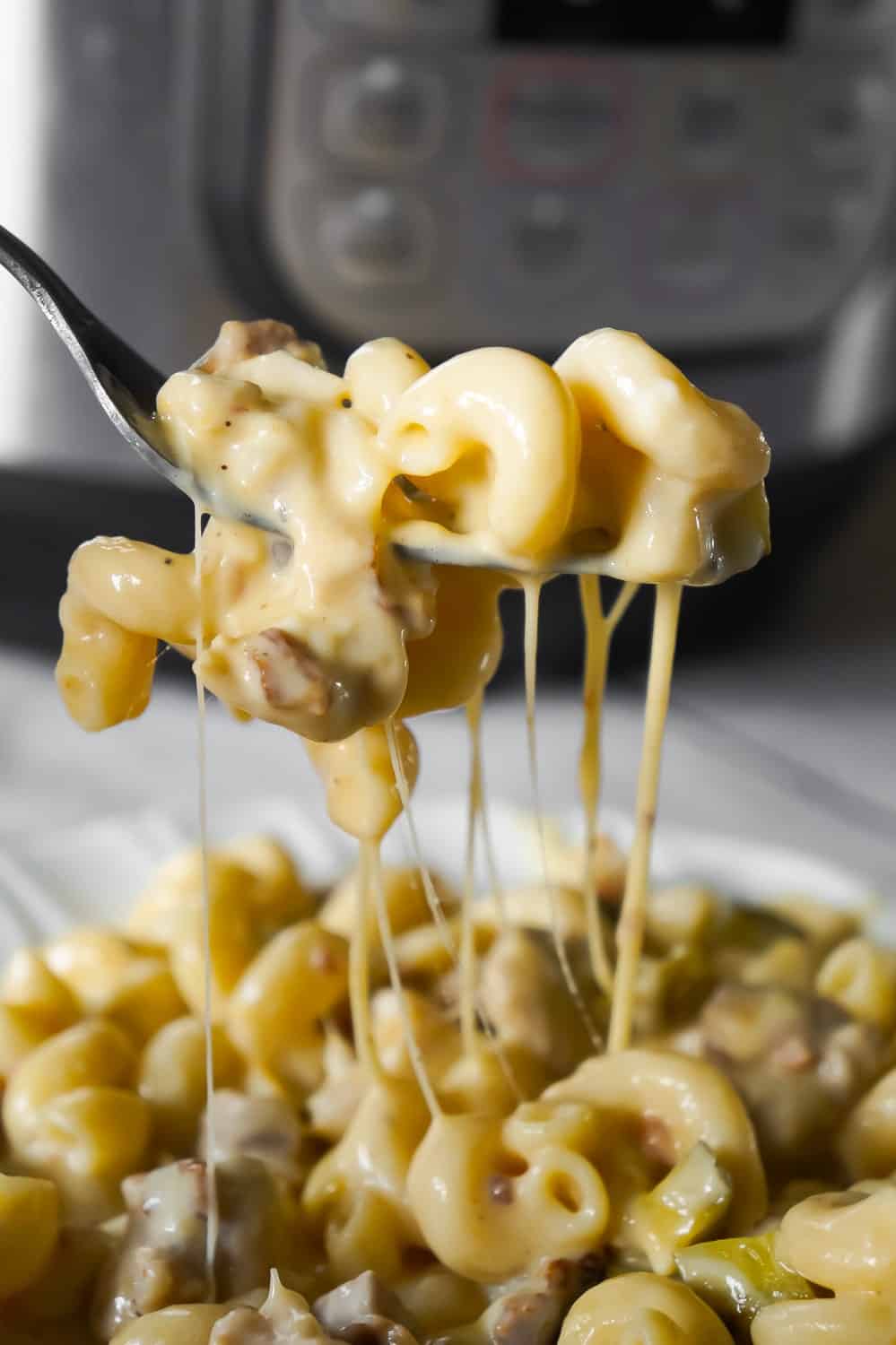 Instant Pot Cheesy Dill Pickle Chicken Pasta is an easy pressure cooker pasta recipe loaded with chunks of chicken, chopped dill pickle, crumbled bacon, cheddar, mozzarella and ranch dressing.
