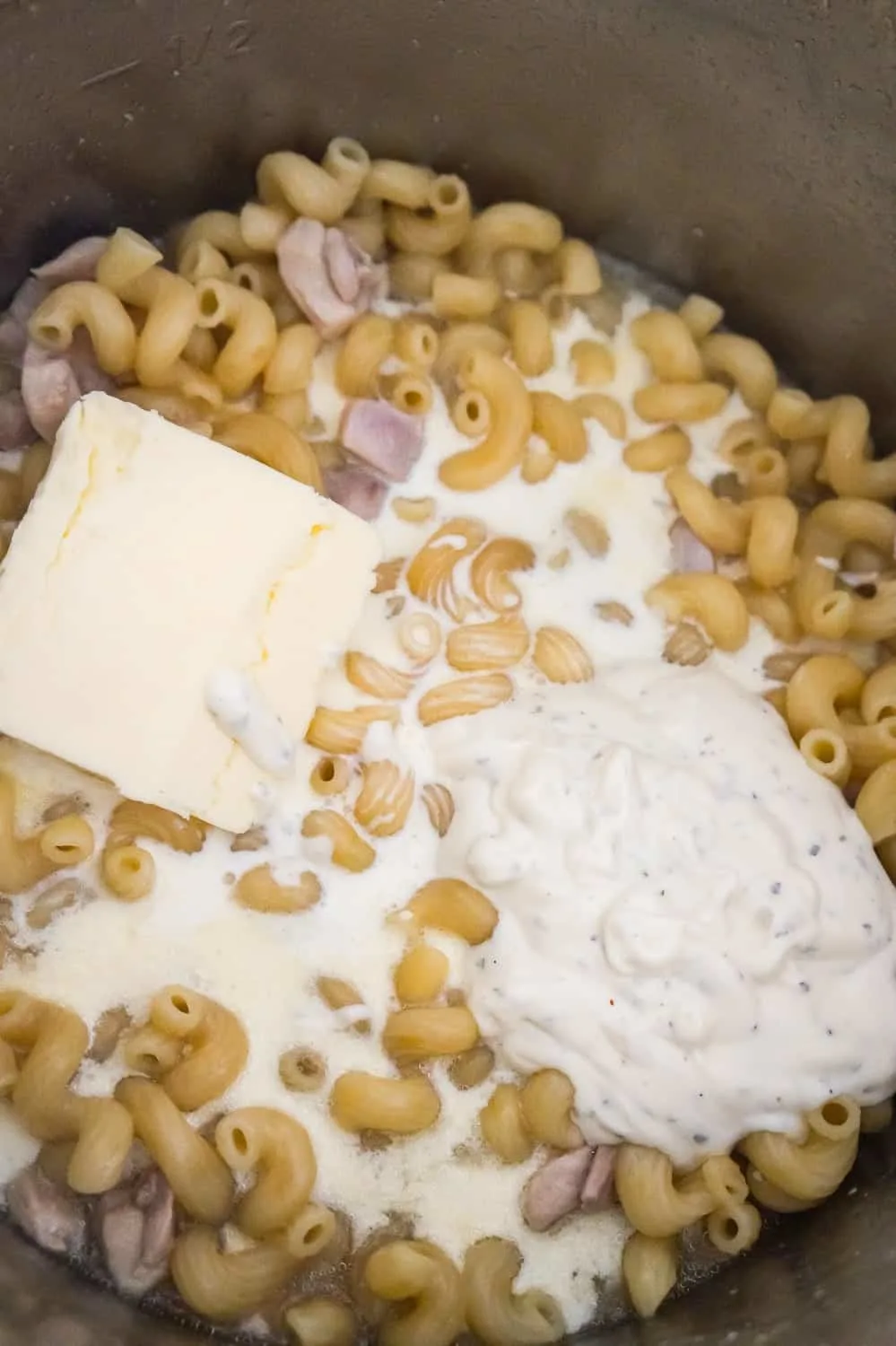 butter, ranch dressing and heavy cream on top of pasta in an Instant Pot