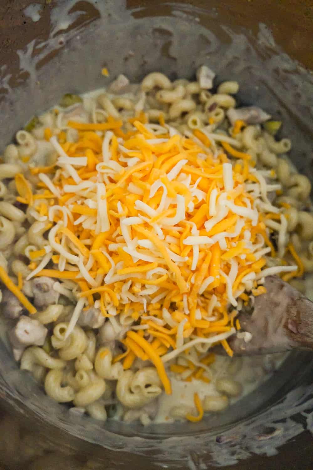 shredded cheddar and mozzarella on top of pasta in an Instant Pot