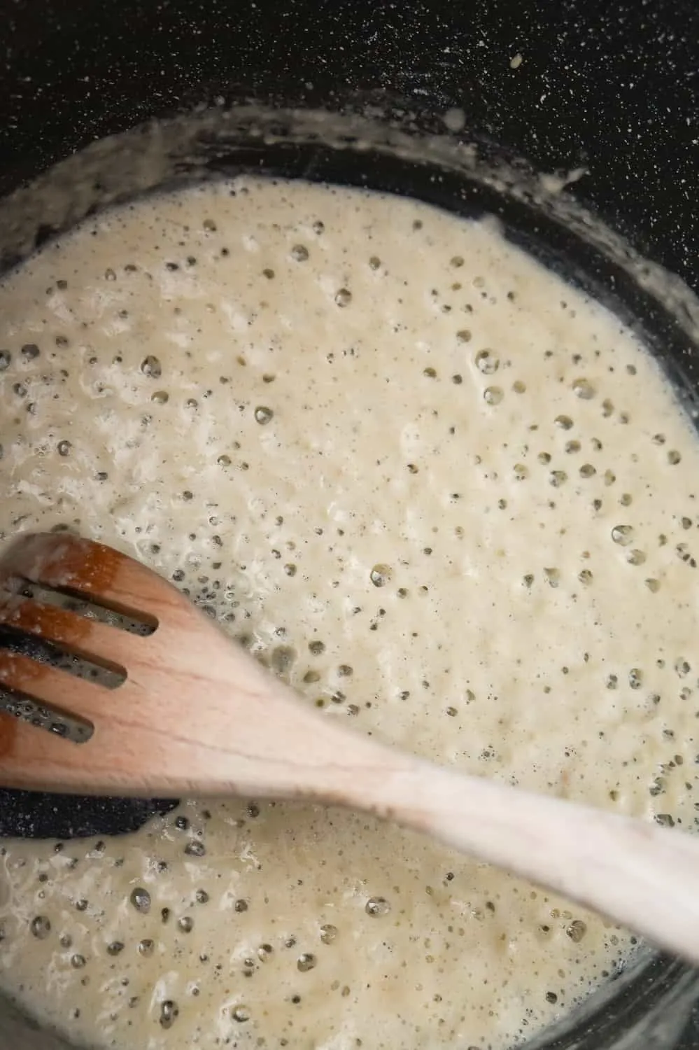 flour, butter and garlic puree cooking in a large pot