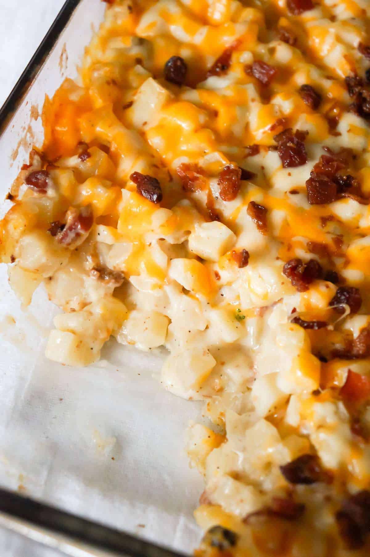 Cheesy Potato Casserole with Bacon is a delicious side dish recipe made with frozen diced hash brown potatoes, Campbell's condensed cream of bacon soup, shredded mozzarella, cheddar and crumbled bacon.