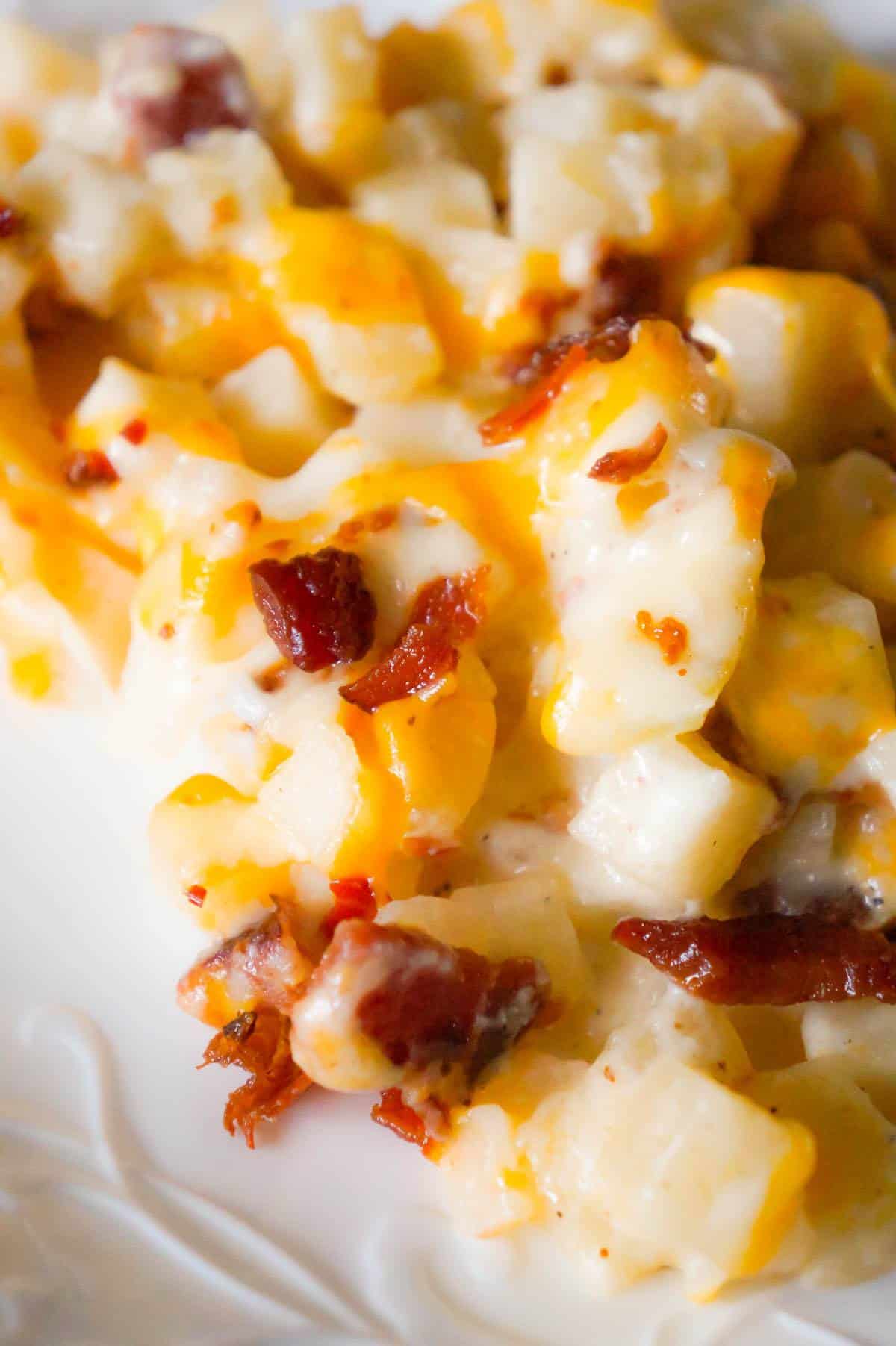 Cheesy Potato Casserole with Bacon is a delicious side dish recipe made with frozen diced hash brown potatoes, Campbell's condensed cream of bacon soup, shredded mozzarella, cheddar and crumbled bacon.