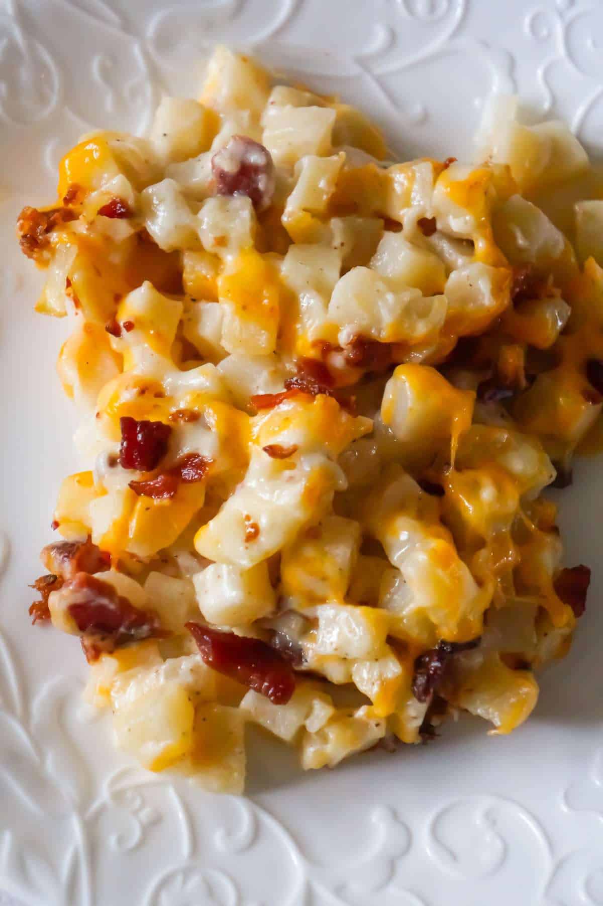 Cheesy Potato Casserole with Bacon is a delicious side dish recipe made with frozen diced hash brown potatoes, Campbell's condensed cream of bacon soup, shredded mozzarella, cheddar and crumbled bacon.