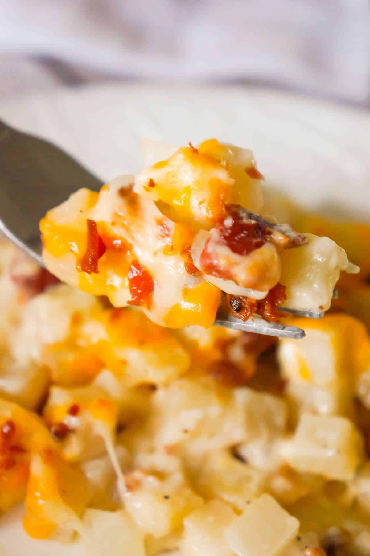 Cheesy Potato Casserole with Bacon is a delicious side dish recipe made with frozen diced hash brown potatoes, Campbell's condensed cream of bacon soup, shredded mozzarella, cheddar and crumbled bacon.