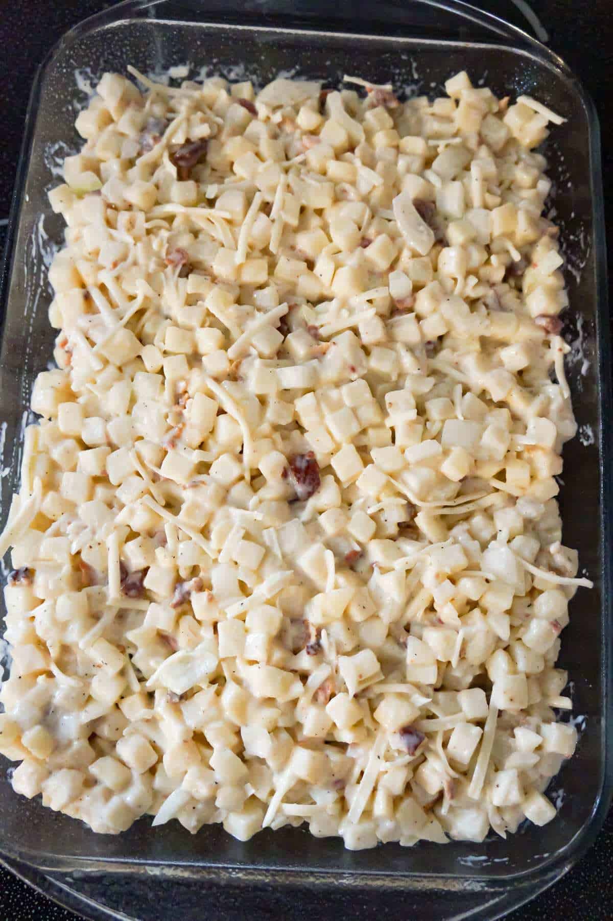 hash brown potato mixture in a baking dish before cooking