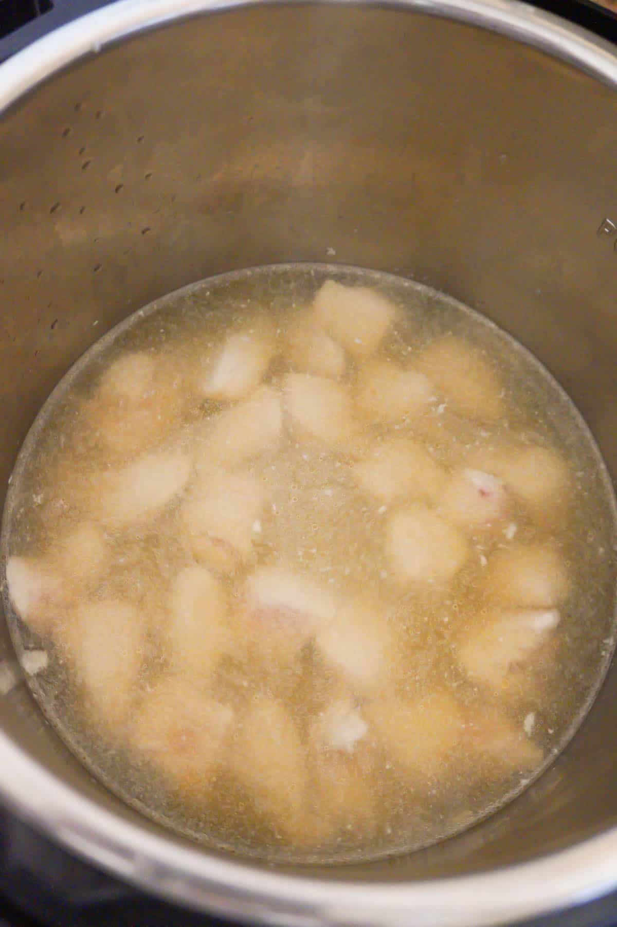 chicken breast chunks in chicken broth in an Instant Pot