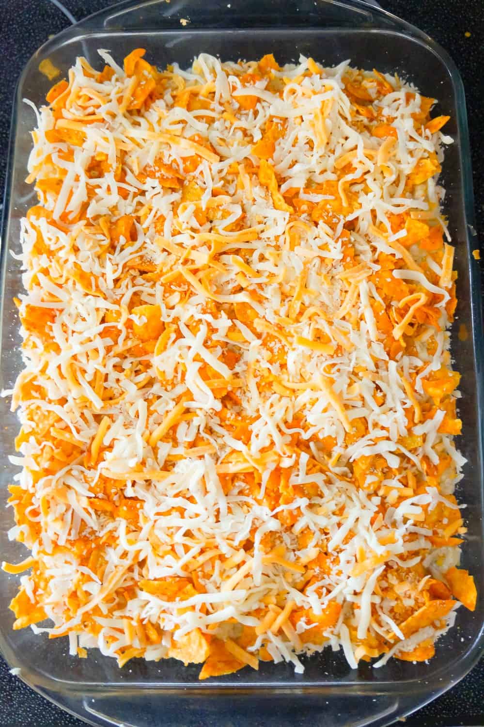 shredded mozzarella and cheddar cheese on top of Doritos casserole