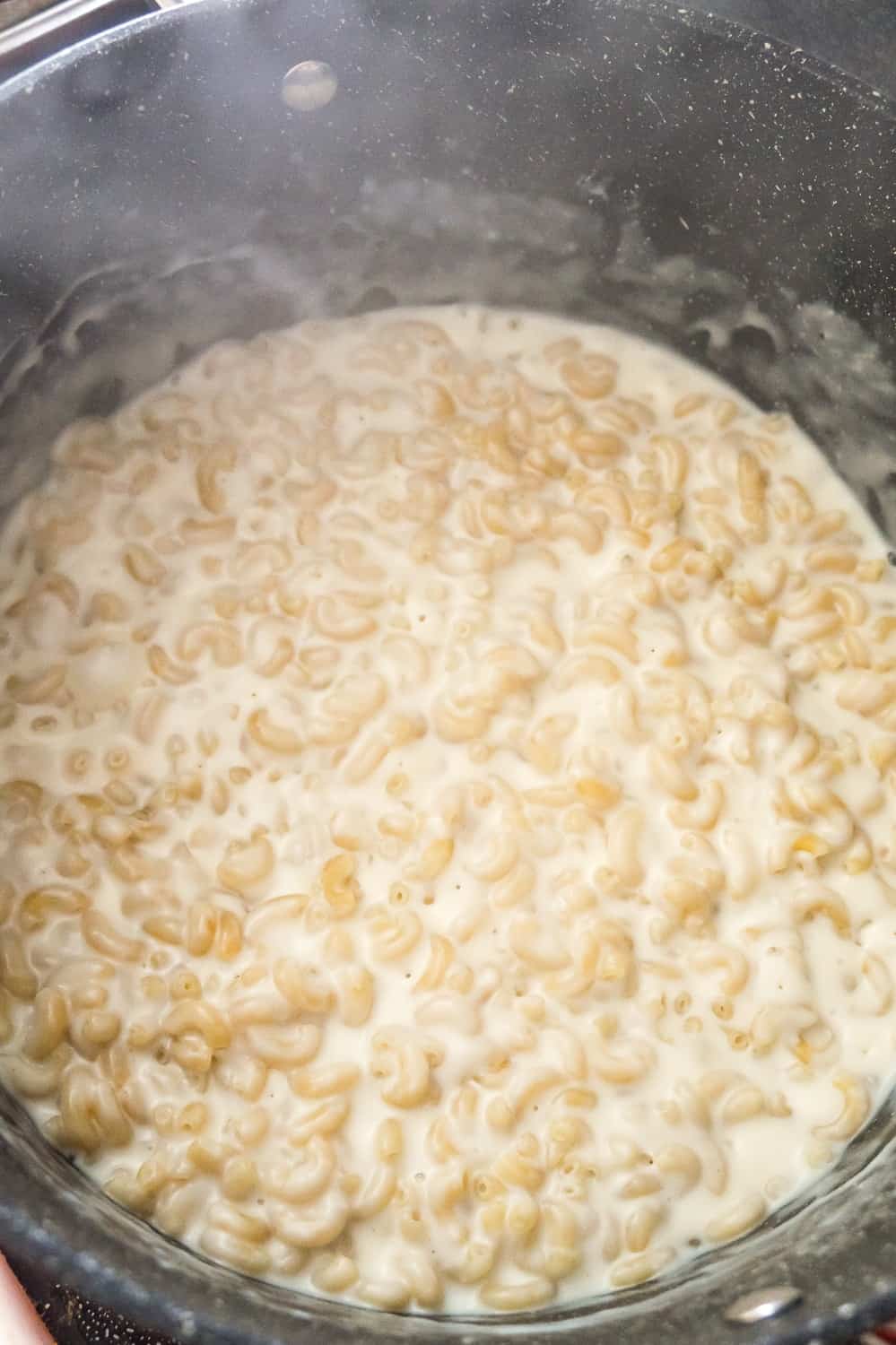 creamy macaroni cooking in a large pot