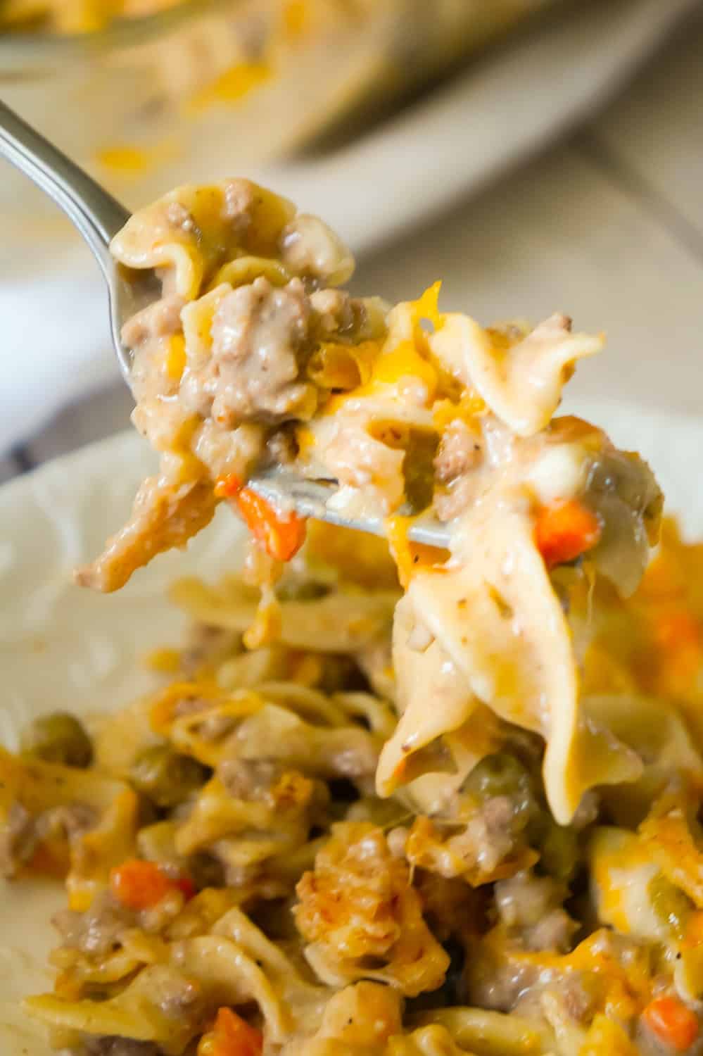 Hamburger Noodle Casserole is an easy ground beef casserole recipe loaded with egg noodles, veggies, cheese and crispy fried onions.