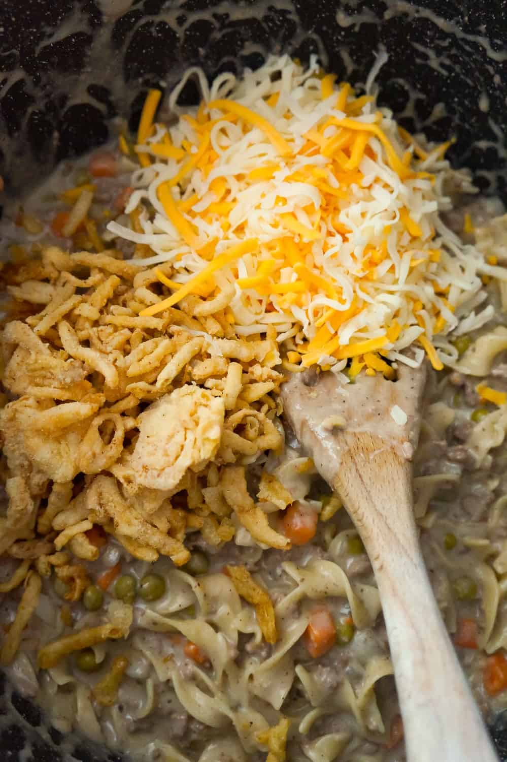 French's fried onions and shredded cheese and to beef and noodle mixture in a large pot