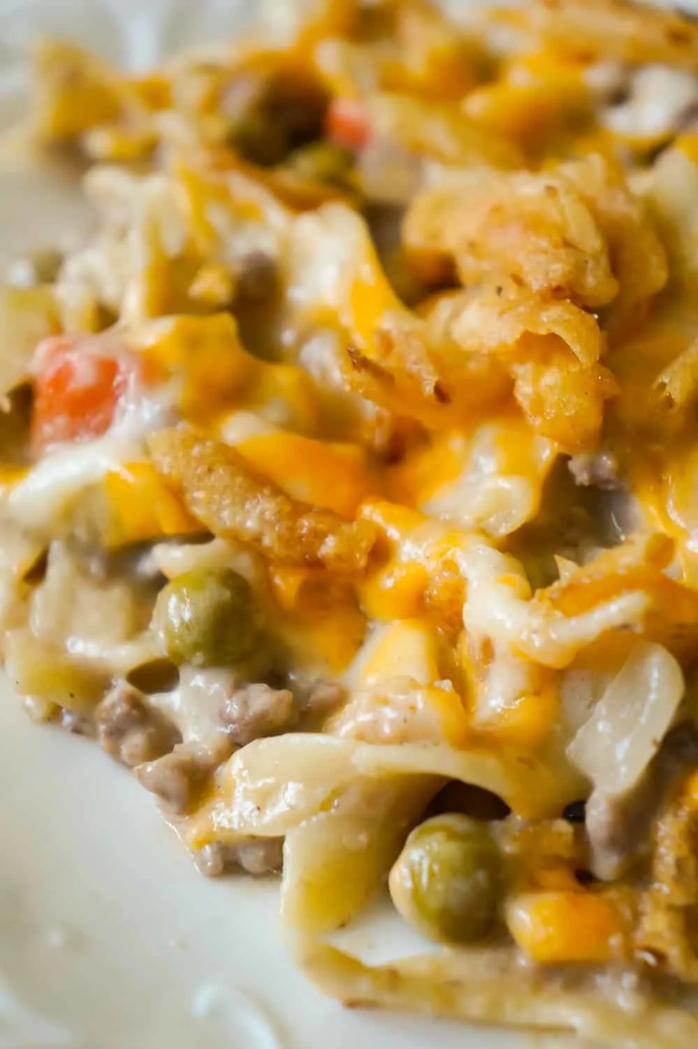 Hamburger Noodle Casserole is an easy ground beef casserole recipe loaded with egg noodles, veggies, cheese and crispy fried onions.