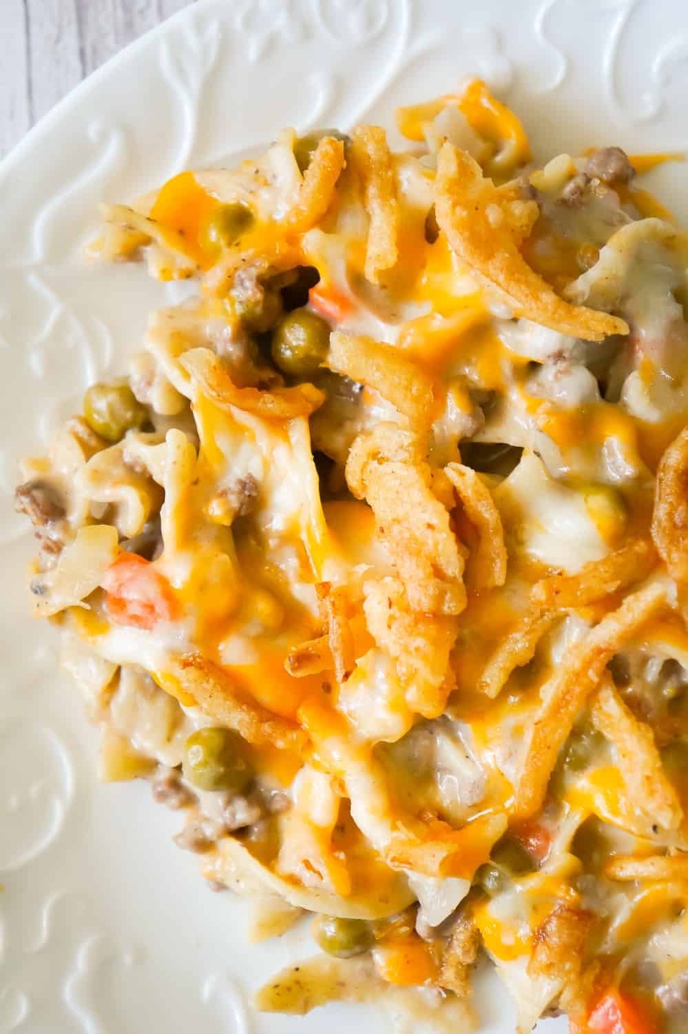 Hamburger Noodle Casserole is an easy ground beef casserole recipe loaded with egg noodles, veggies, cheese and crispy fried onions.