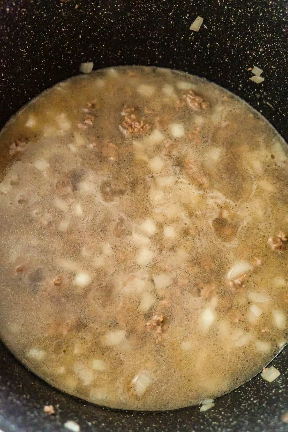 water, cooked ground beef and diced onions in a large pot