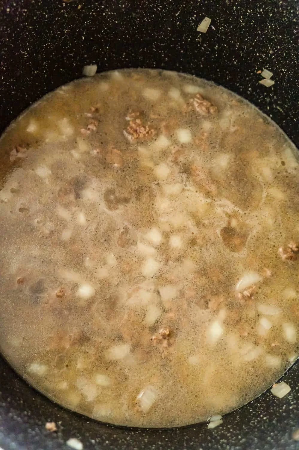 water, cooked ground beef and diced onions in a large pot