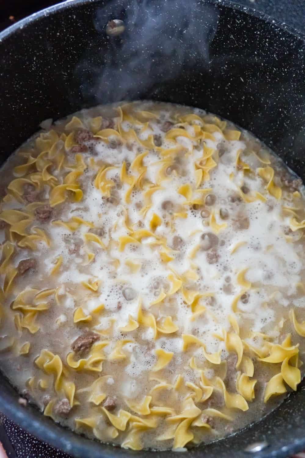 egg noodle and ground beef cooking in a large pot