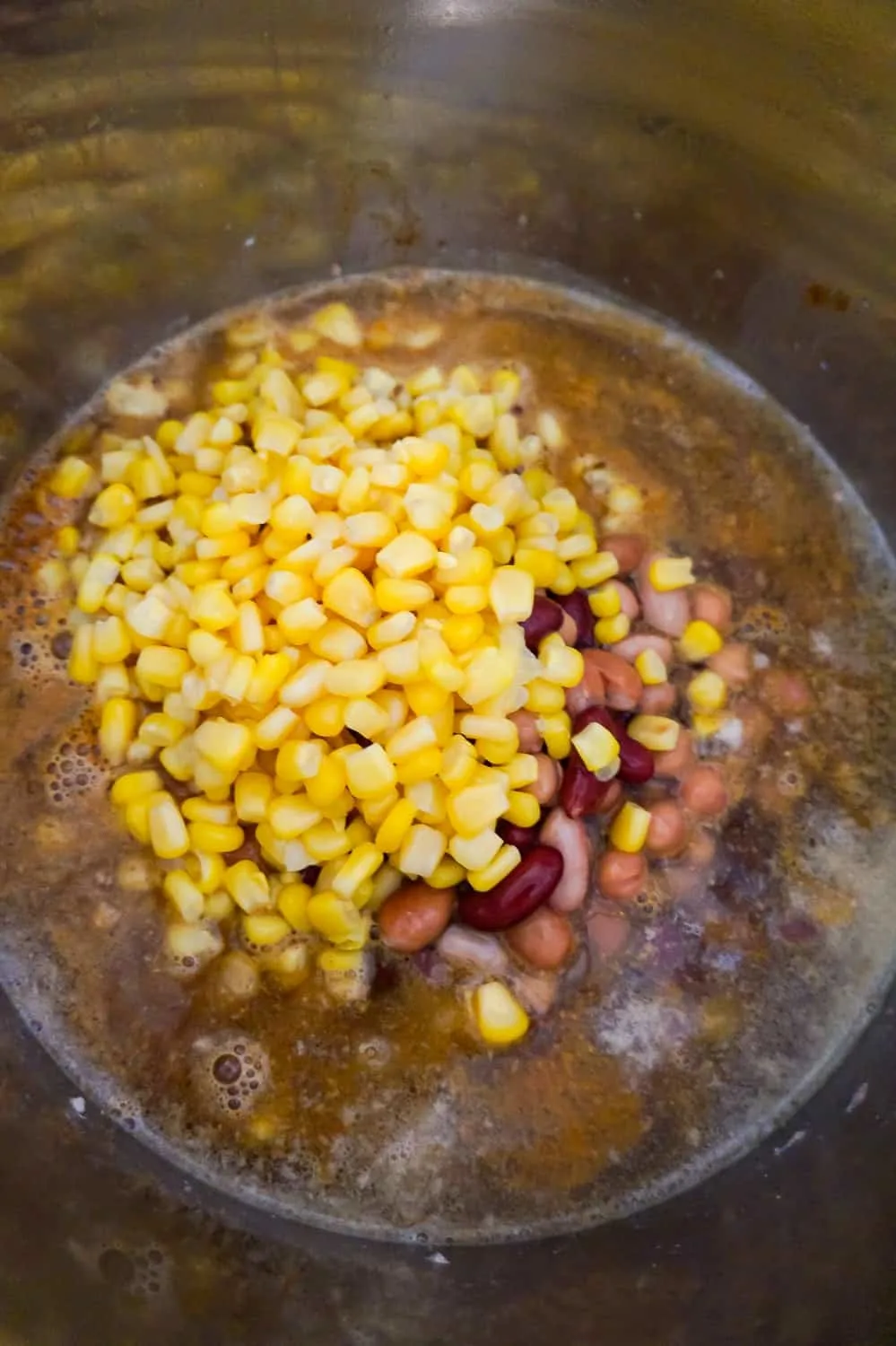 corn and six been medley on top of ground turkey in an instant pot