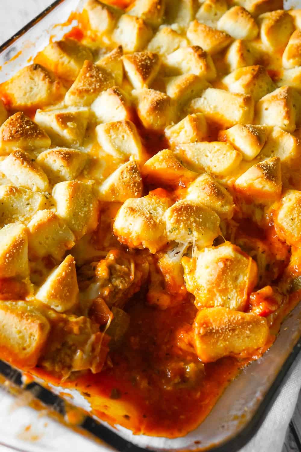 Meatball Casserole with Biscuits is an easy dinner recipe made with frozen meatballs, Pillsbury Biscuits, red and green peppers and loaded with mozzarella and cheddar cheese.