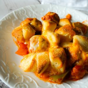 Meatball Casserole with Biscuits is an easy dinner recipe made with frozen meatballs, Pillsbury Biscuits, red and green peppers and loaded with mozzarella and cheddar cheese.