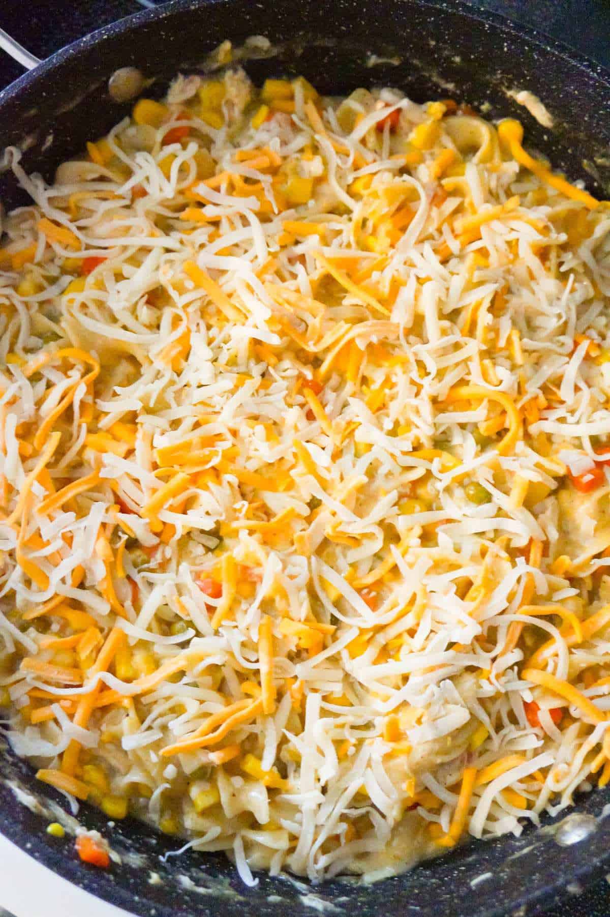 shredded mozzarella and cheddar on top of stove top chicken noodle casserole