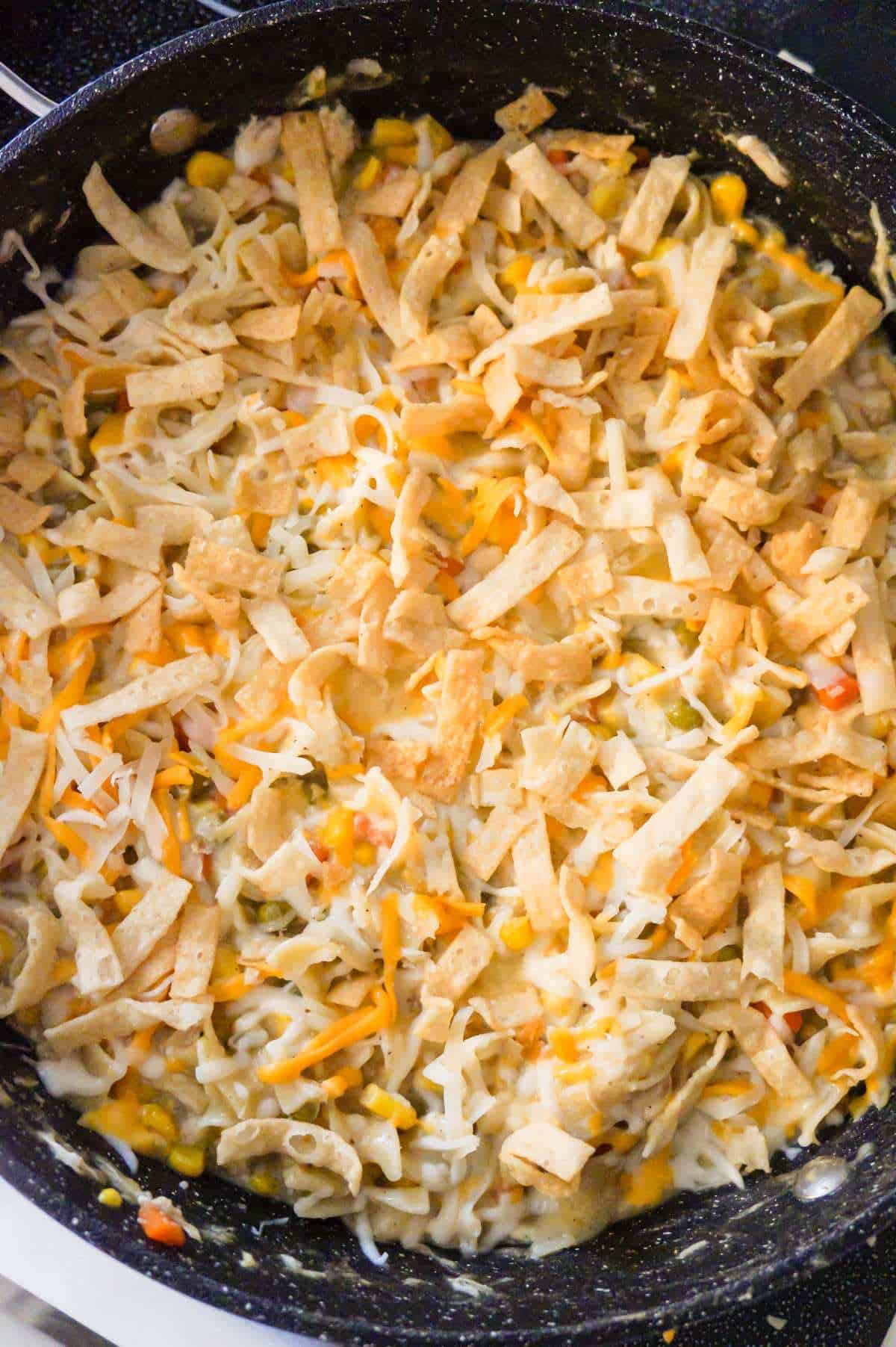 crispy fried wonton strips and shredded cheese on top of stove top chicken noodle casserole