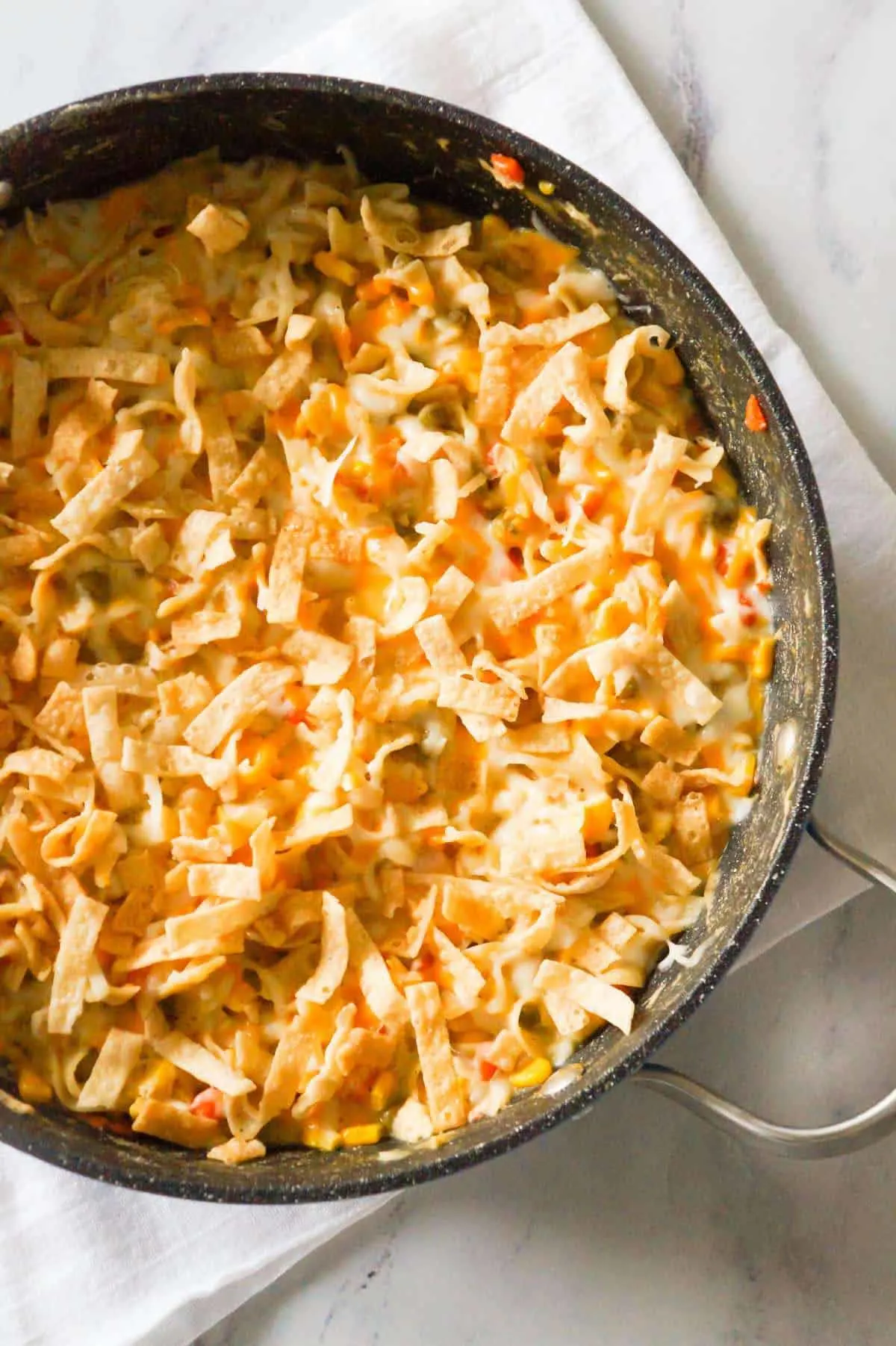 One Pot Chicken Noodle Casserole is a hearty stove top dinner recipe loaded with egg noodles, shredded rotisserie chicken and veggies, topped with cheese and crispy fried Wonton strips.