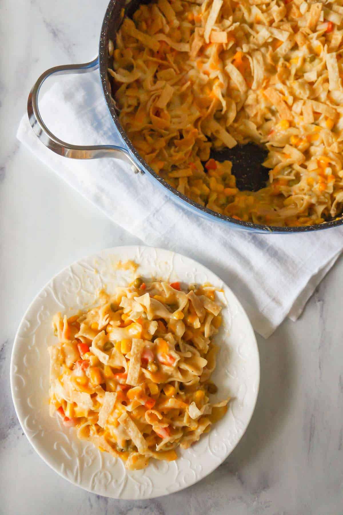 One Pot Chicken Noodle Casserole is a hearty stove top dinner recipe loaded with egg noodles, shredded rotisserie chicken and veggies, topped with cheese and crispy fried Wonton strips.