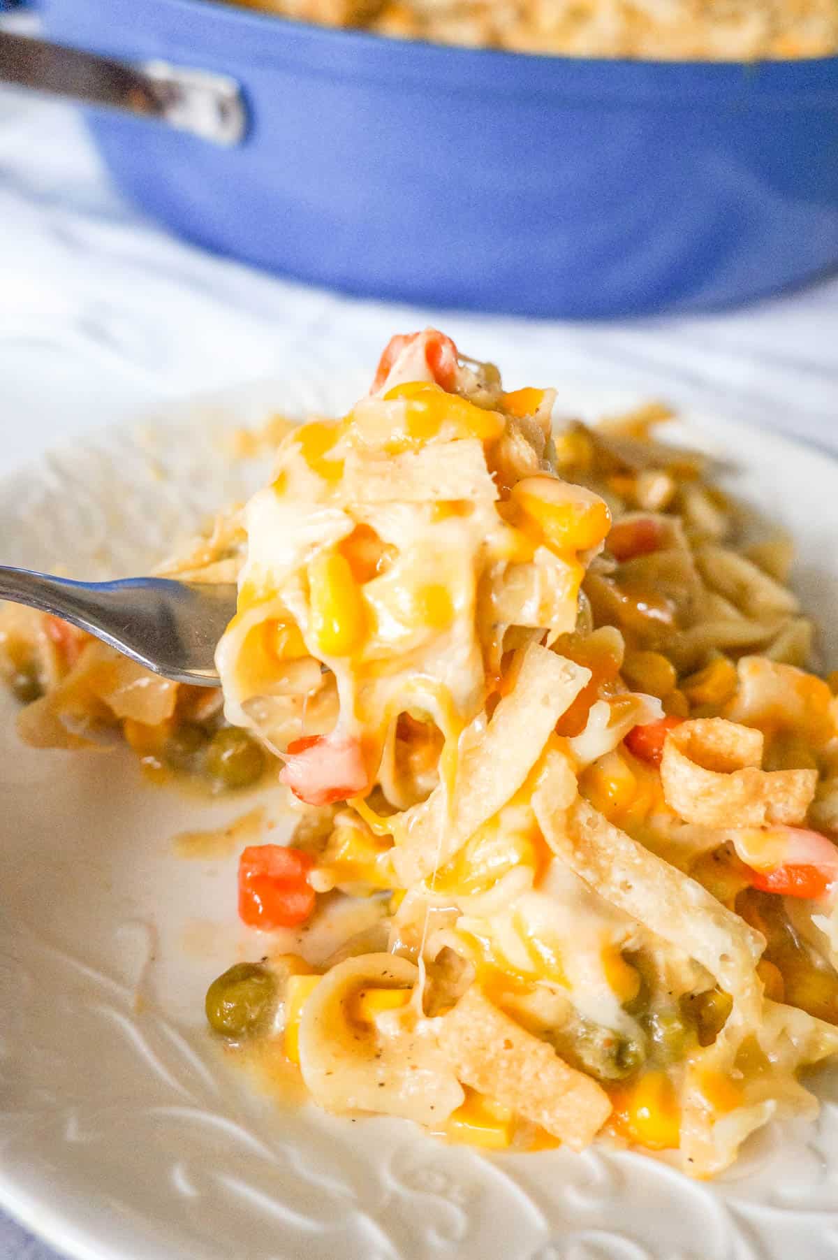 One Pot Chicken Noodle Casserole is a hearty stove top dinner recipe loaded with egg noodles, shredded rotisserie chicken and veggies, topped with cheese and crispy fried Wonton strips.