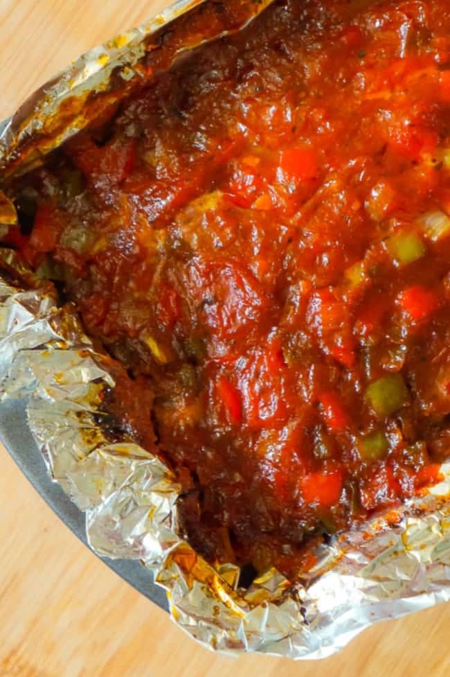 Sausage and Peppers Meatloaf is an easy meatloaf recipe using two pounds of mild Italian sausage meat and loaded with diced green peppers, red peppers and onions all in a sweet and spicy tomato sauce.