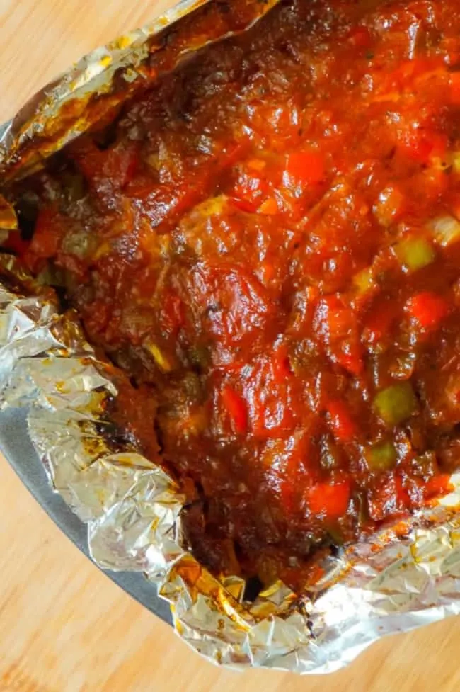 Sausage and Peppers Meatloaf is an easy meatloaf recipe using two pounds of mild Italian sausage meat and loaded with diced green peppers, red peppers and onions all in a sweet and spicy tomato sauce.
