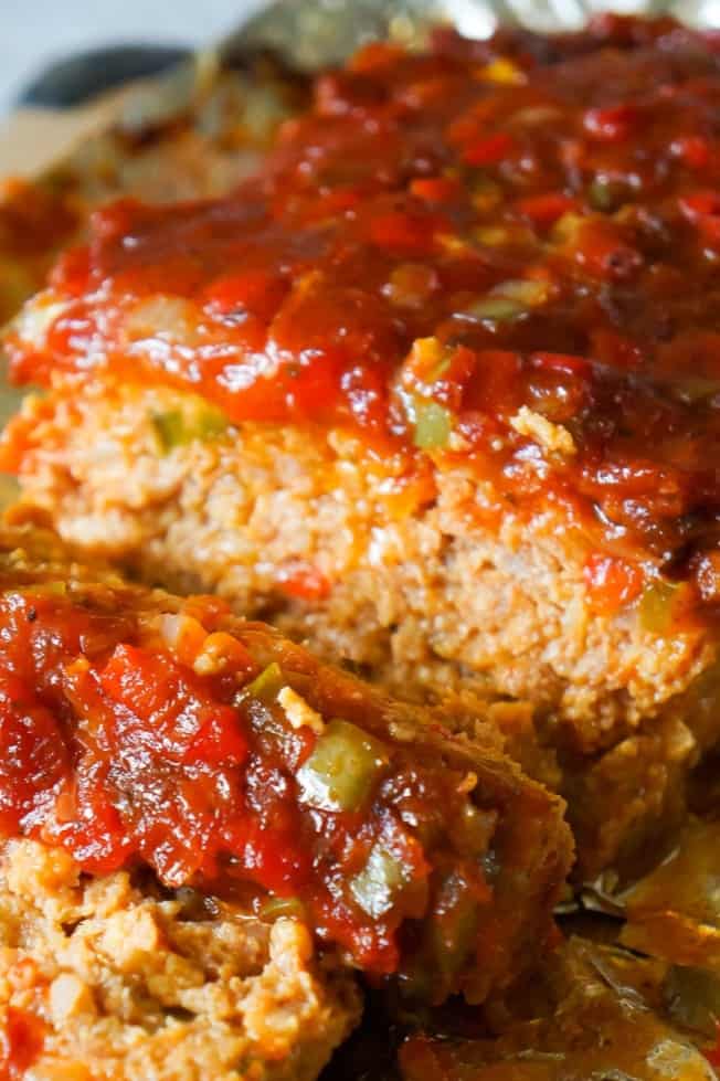 Sausage and Peppers Meatloaf is an easy meatloaf recipe using two pounds of mild Italian sausage meat and loaded with diced green peppers, red peppers and onions all in a sweet and spicy tomato sauce.