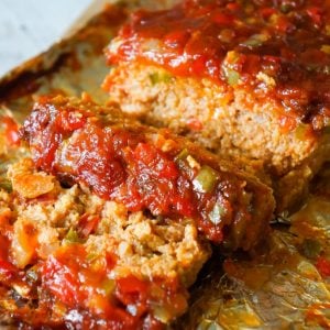 Sausage and Peppers Meatloaf is an easy meatloaf recipe using two pounds of mild Italian sausage meat and loaded with diced green peppers, red peppers and onions all in a sweet and spicy tomato sauce.