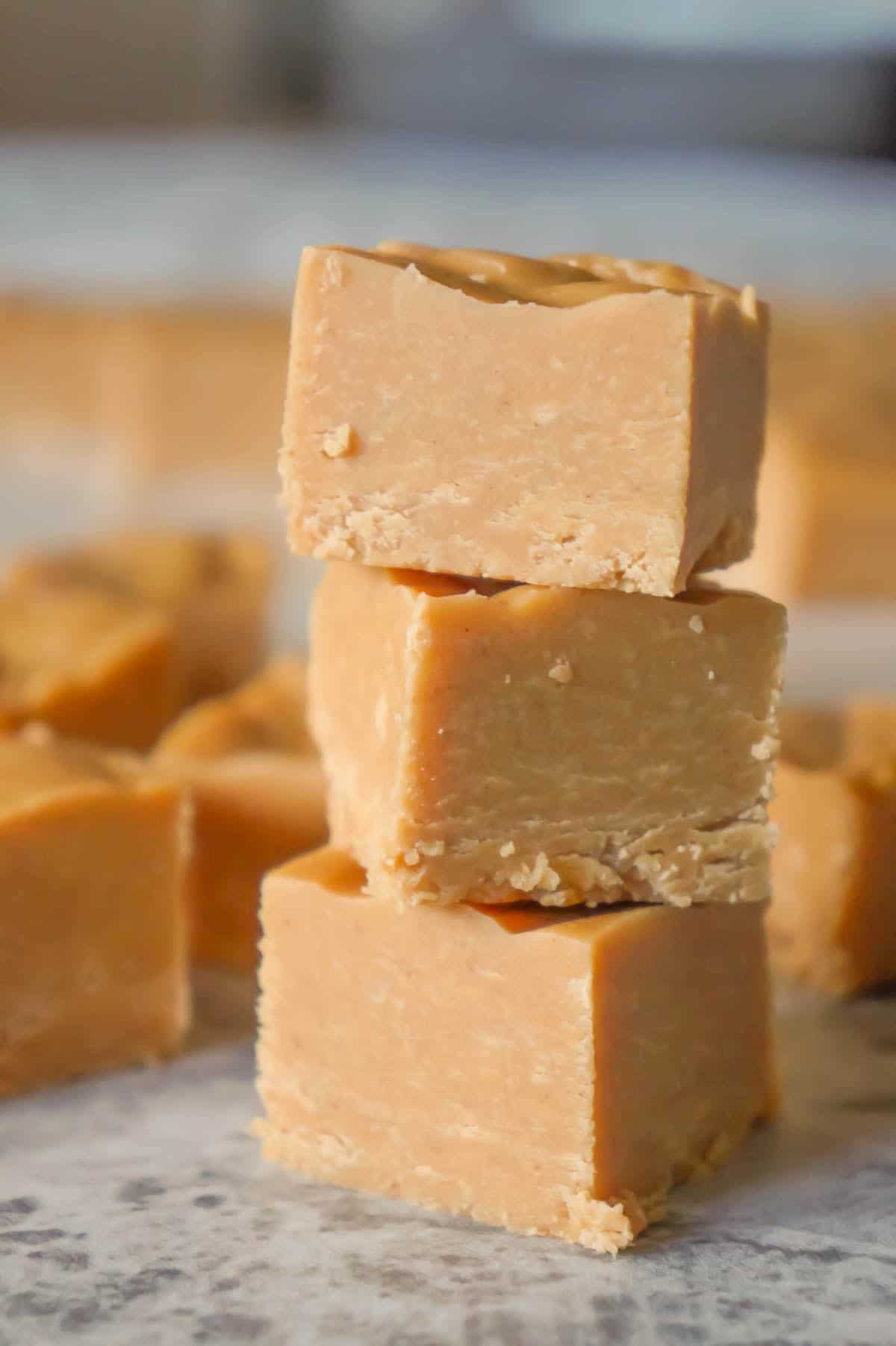 Easy Peanut Butter Fudge is an easy three ingredient microwave fudge recipe made with vanilla frosting, Reese's peanut butter baking chips and smooth peanut butter.