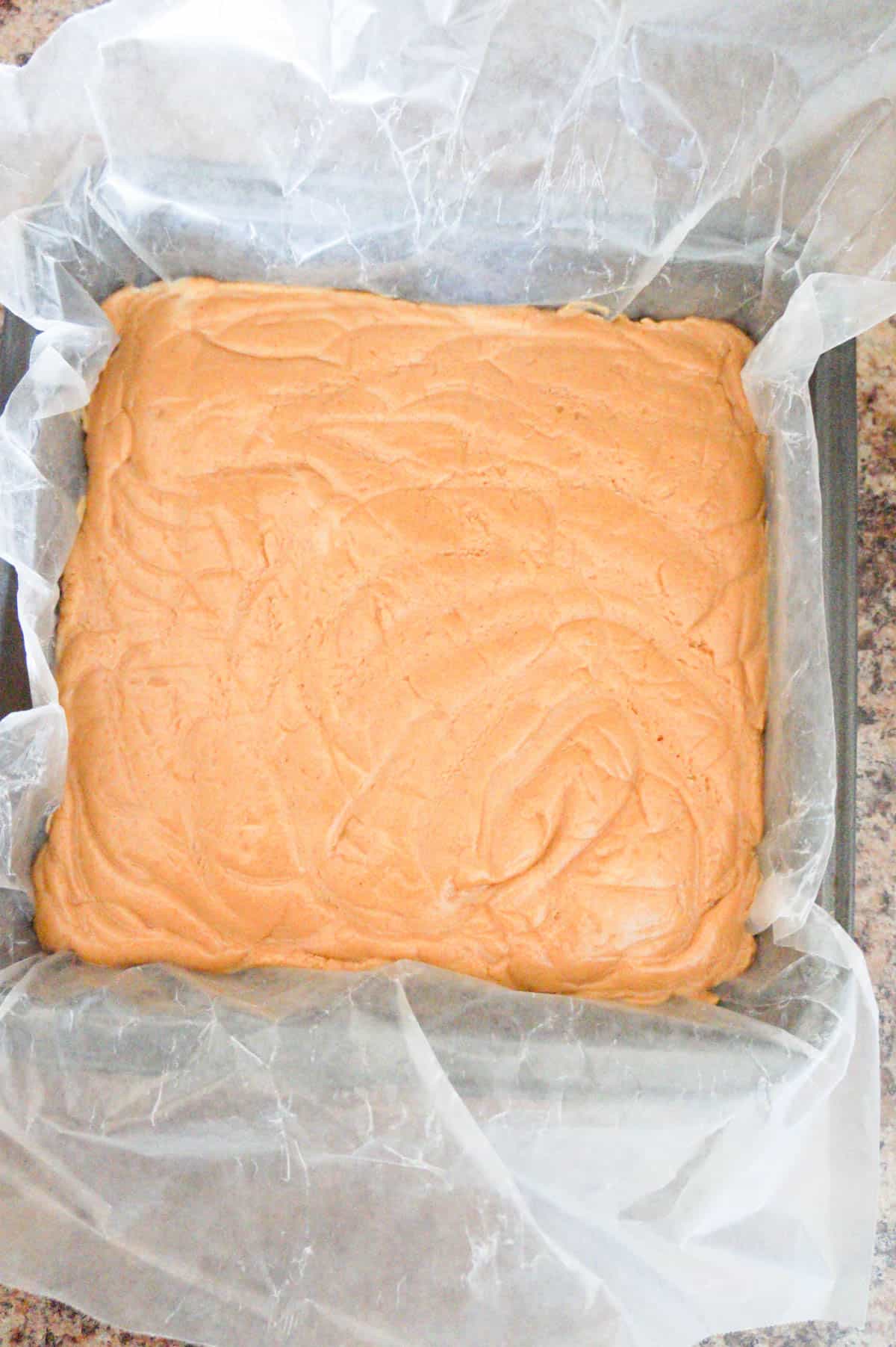 creamy peanut butter fudge in a baking pan before setting
