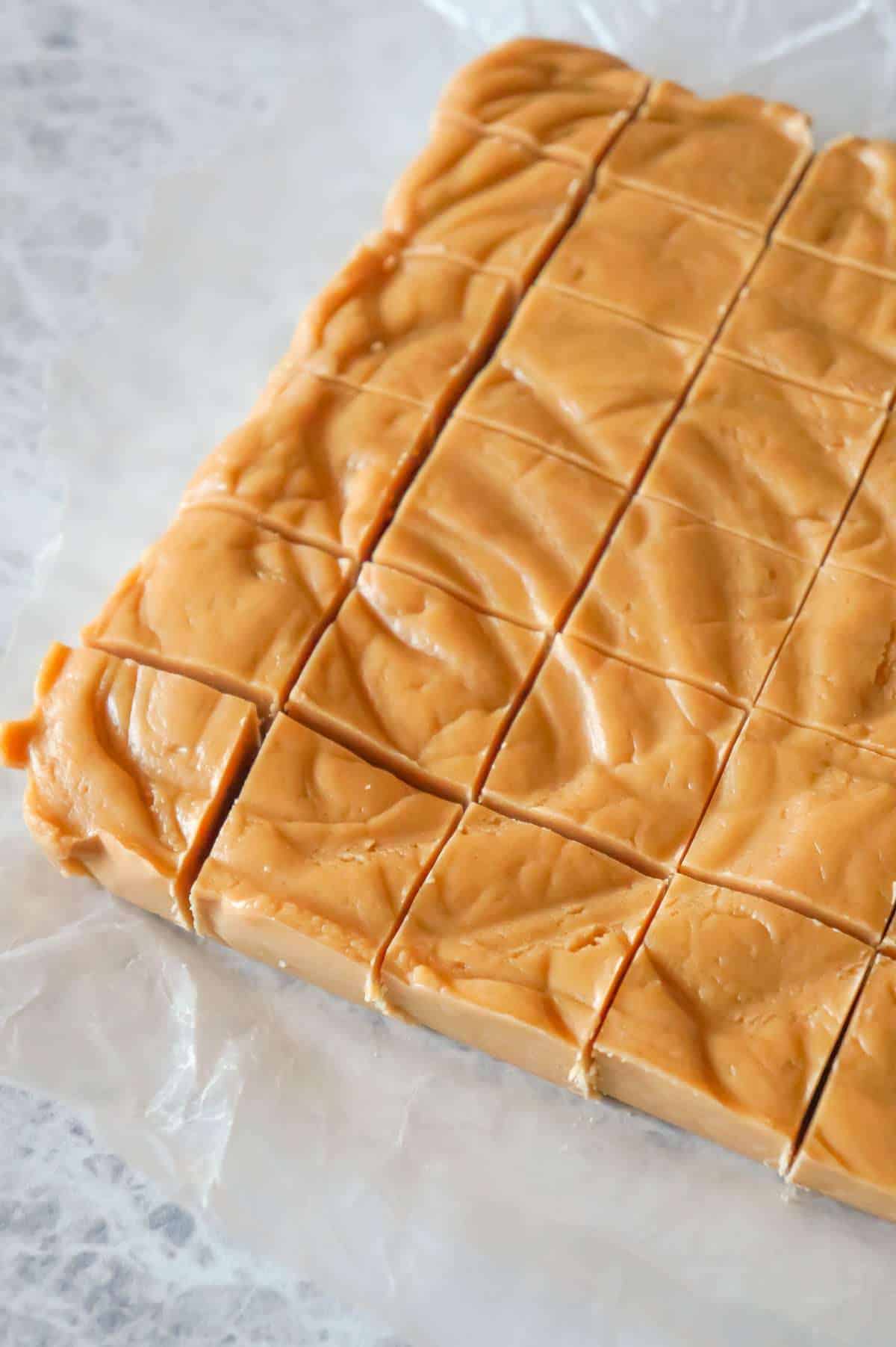 Easy Peanut Butter Fudge is an easy three ingredient microwave fudge recipe made with vanilla frosting, Reese's peanut butter baking chips and smooth peanut butter.