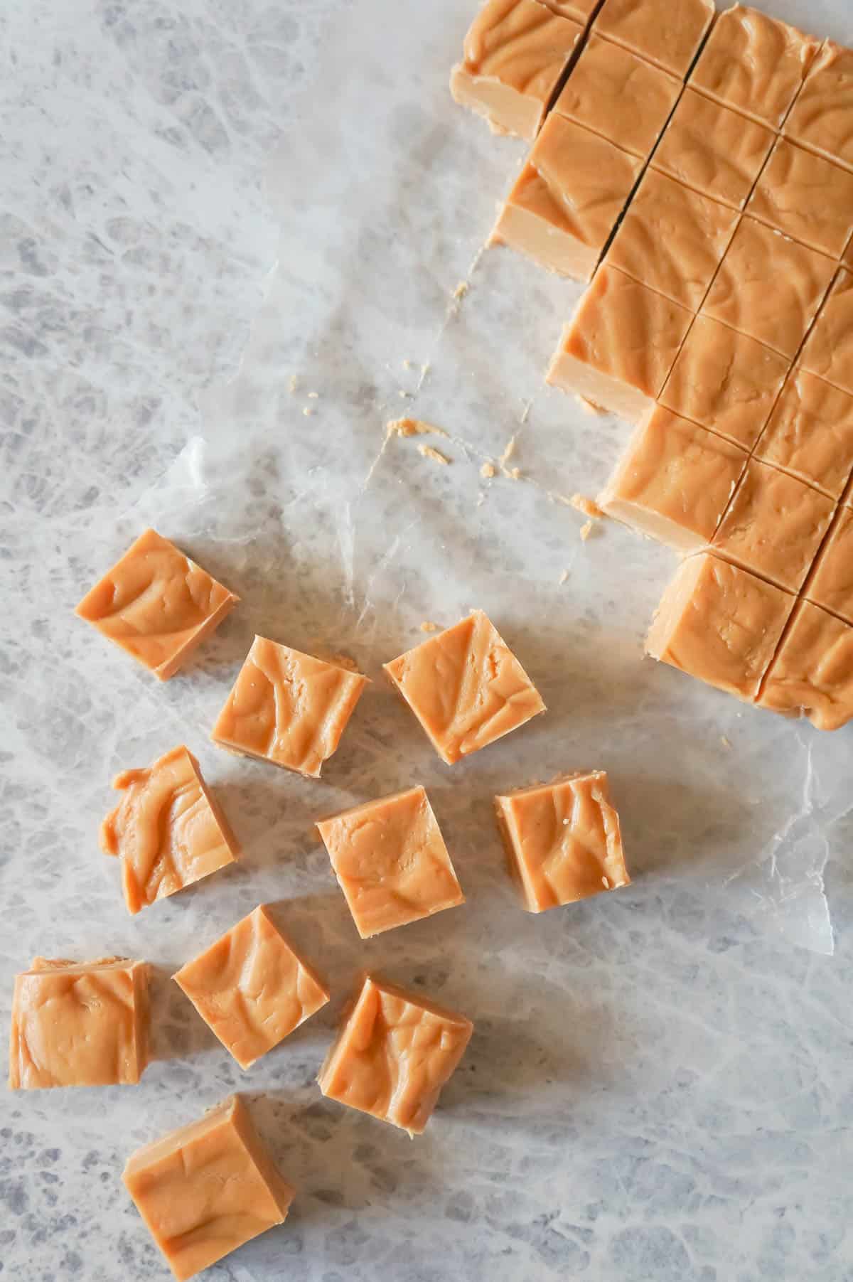 Easy Peanut Butter Fudge is an easy three ingredient microwave fudge recipe made with vanilla frosting, Reese's peanut butter baking chips and smooth peanut butter.