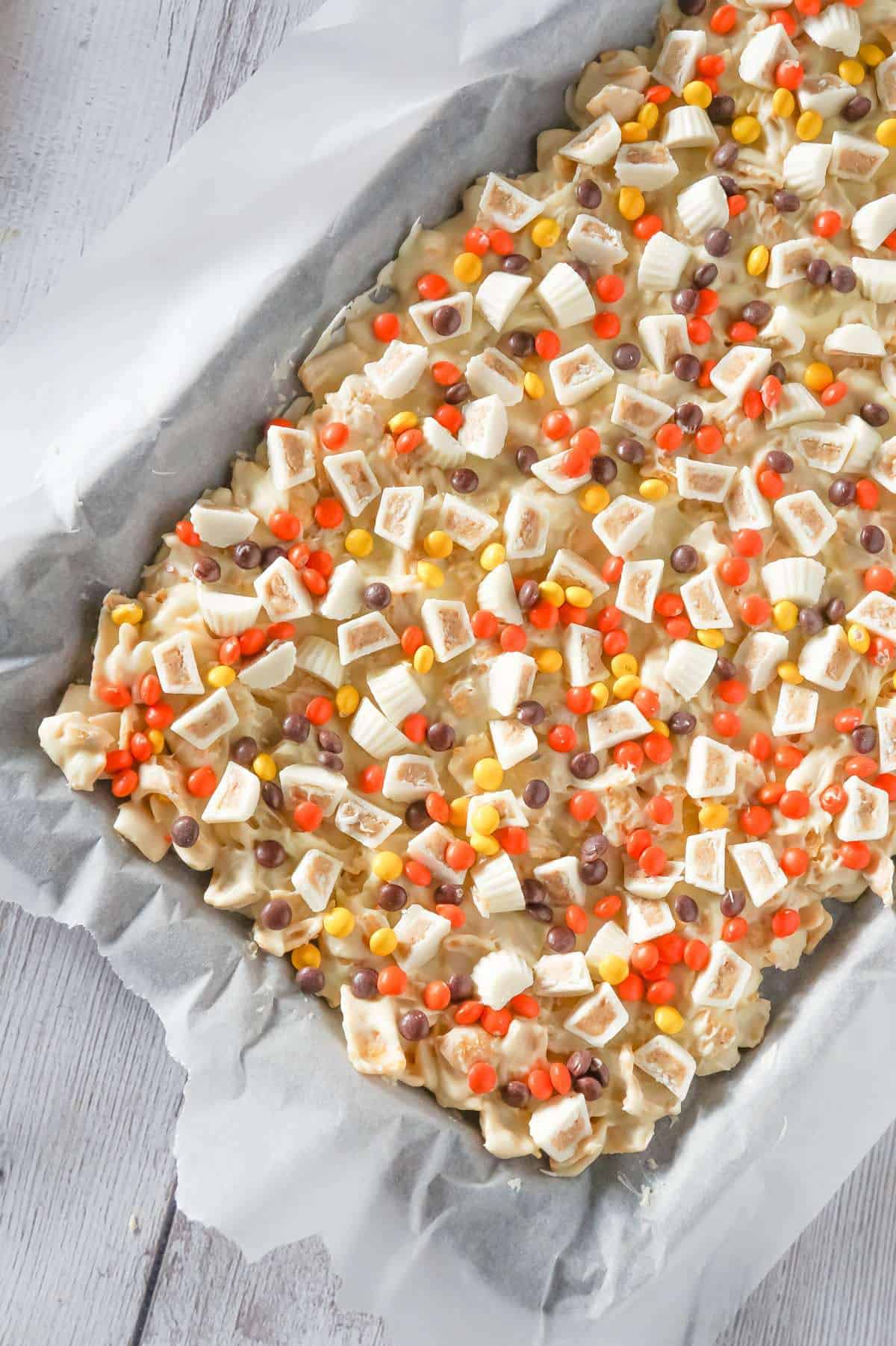 Fritos White Chocolate Peanut Butter Cup Bark is a sweet and salty dessert recipe made with white chocolate chips, Fritos corn chips, mini white chocolate Reese's peanut butter cups and mini Reese's pieces.