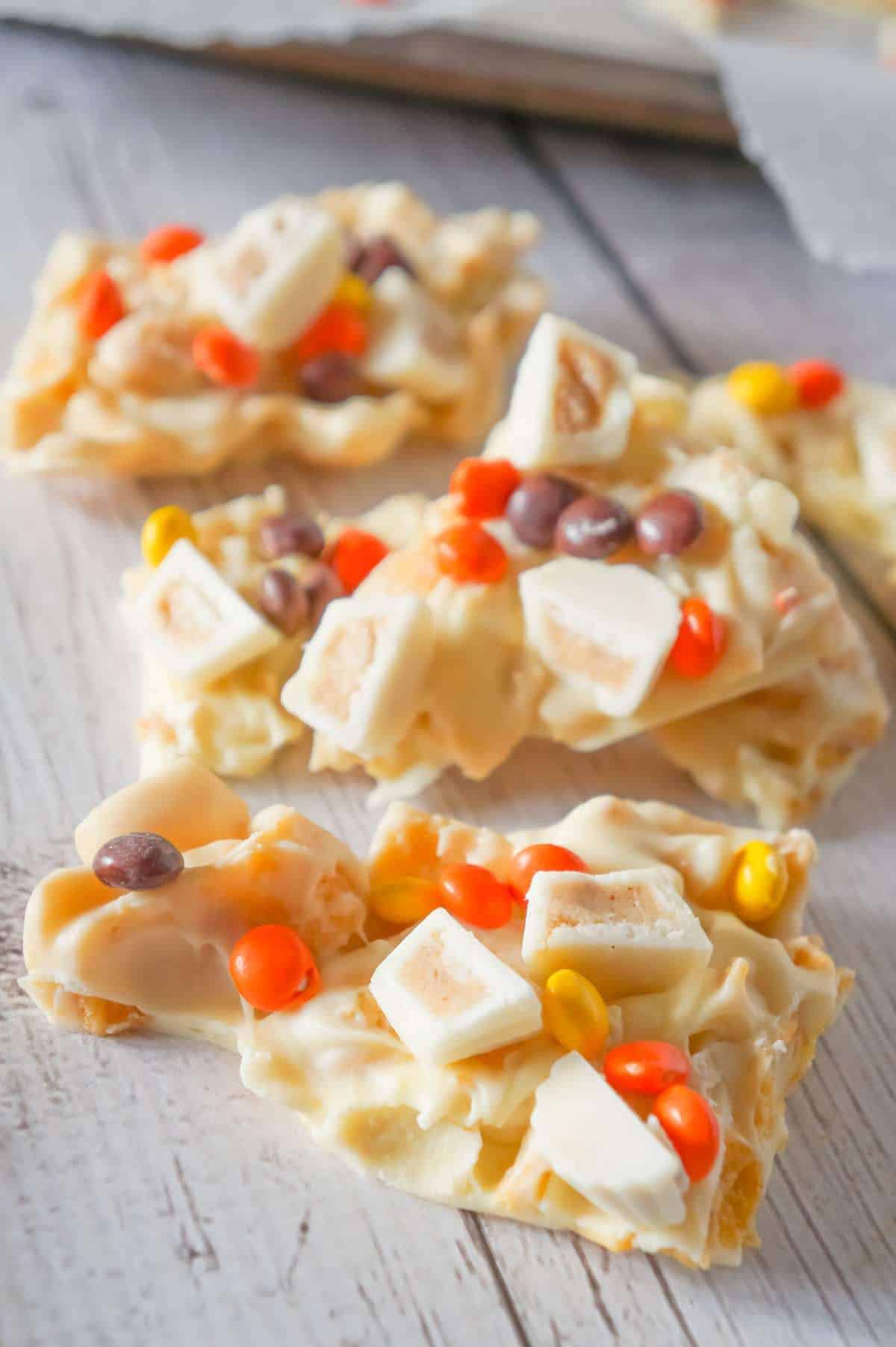 Fritos White Chocolate Peanut Butter Cup Bark is a sweet and salty dessert recipe made with white chocolate chips, Fritos corn chips, mini white chocolate Reese's peanut butter cups and mini Reese's pieces.