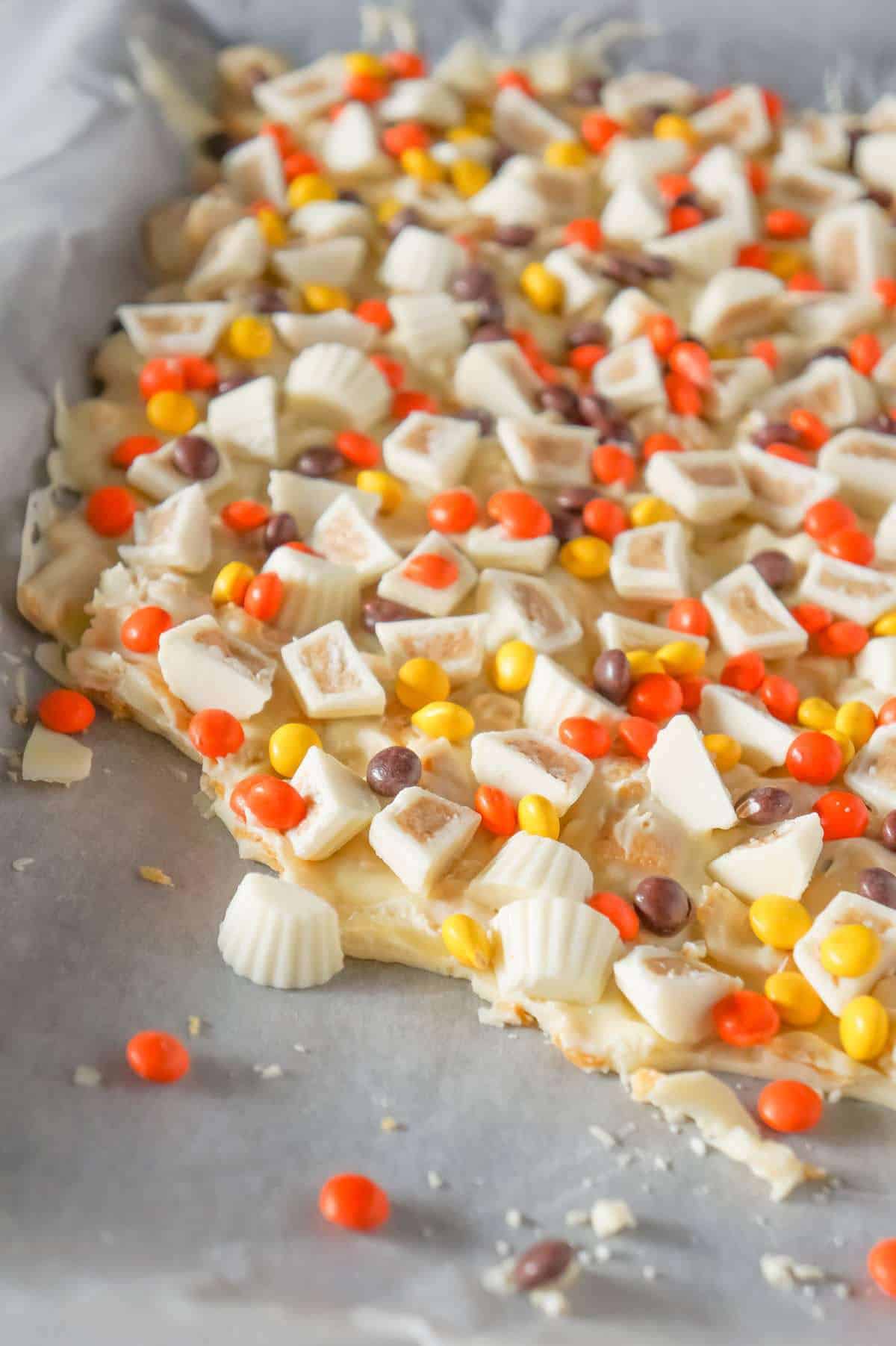 Fritos White Chocolate Peanut Butter Cup Bark is a sweet and salty dessert recipe made with white chocolate chips, Fritos corn chips, mini white chocolate Reese's peanut butter cups and mini Reese's pieces.