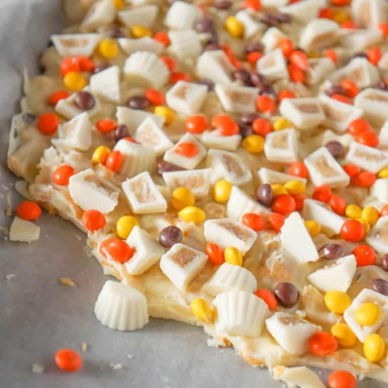 Fritos White Chocolate Peanut Butter Cup Bark is a sweet and salty dessert recipe made with white chocolate chips, Fritos corn chips, mini white chocolate Reese's peanut butter cups and mini Reese's pieces.