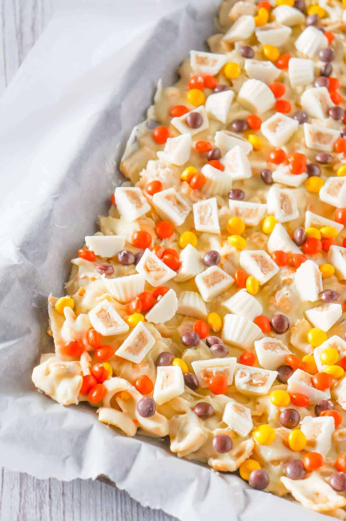 Fritos White Chocolate Peanut Butter Cup Bark is a sweet and salty dessert recipe made with white chocolate chips, Fritos corn chips, mini white chocolate Reese's peanut butter cups and mini Reese's pieces.